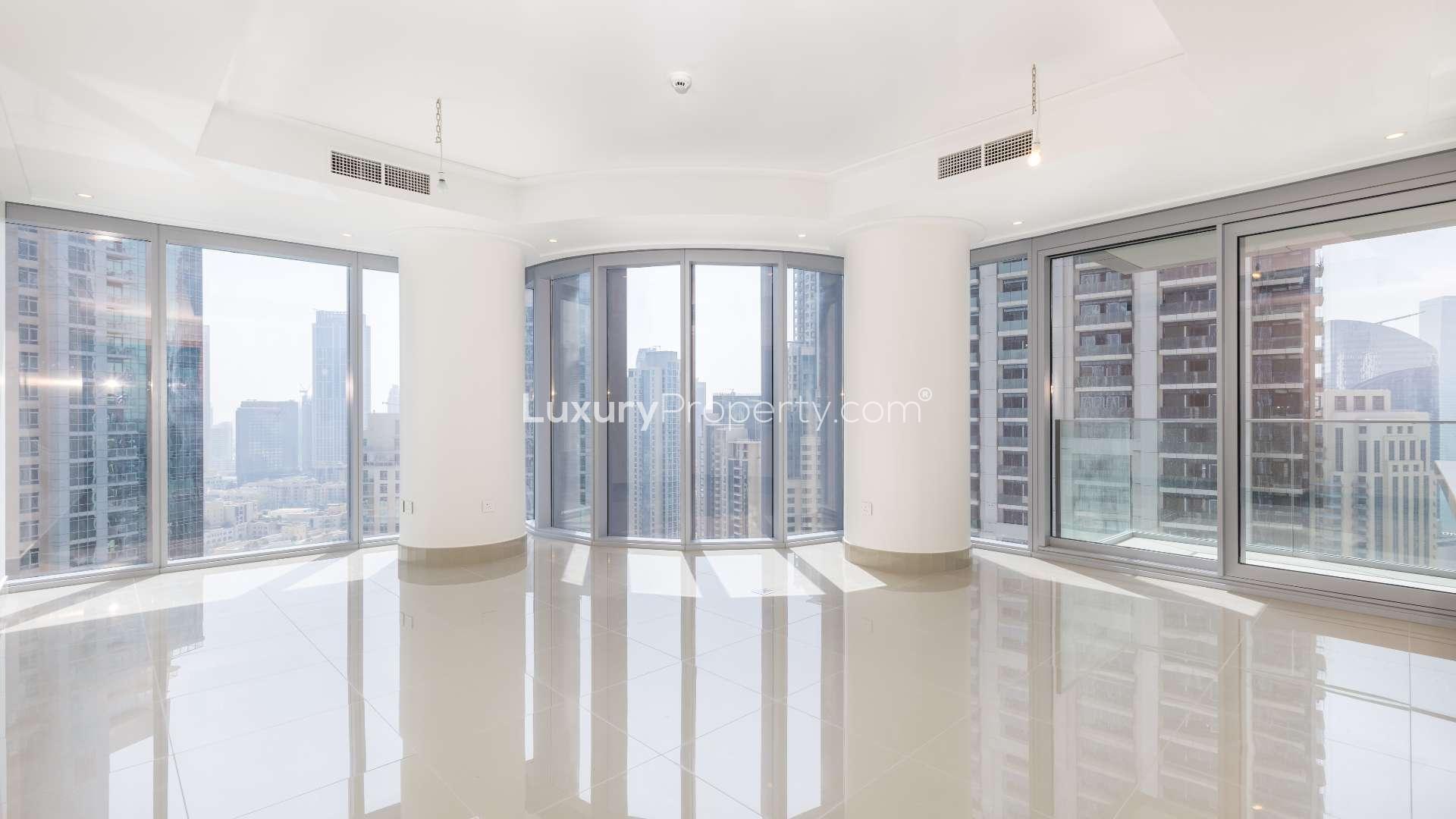 Alt text: "View of Burj Khalifa and Dubai Fountain from Downtown Dubai apartment for rent.",Bright, spacious apartment with floor-to-ceiling windows, Burj Khalifa and Dubai Fountain views