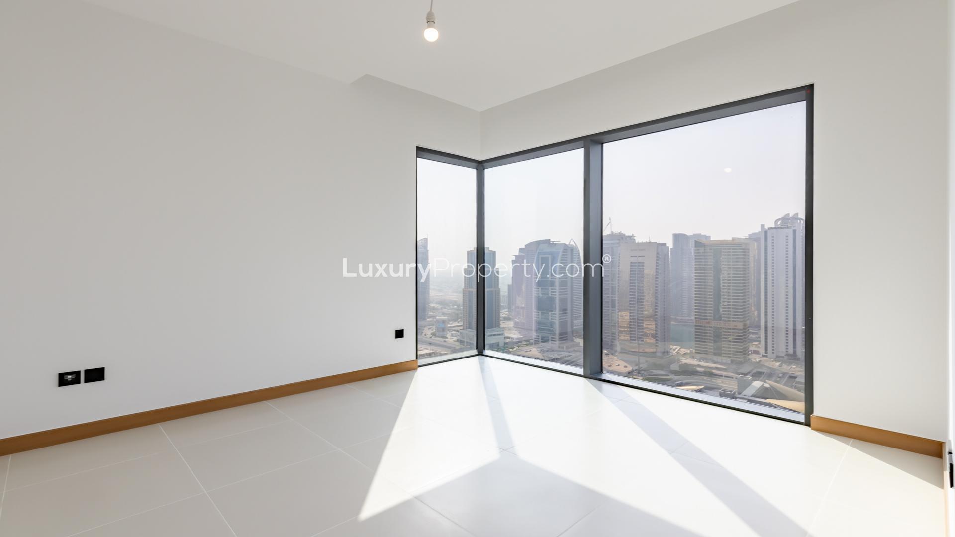 "Stunning Dubai Marina skyline view from Vida Residence apartment balcony, LP39175 rental listing.",Empty room with large windows and city view at Vida Residence, Dubai Marina