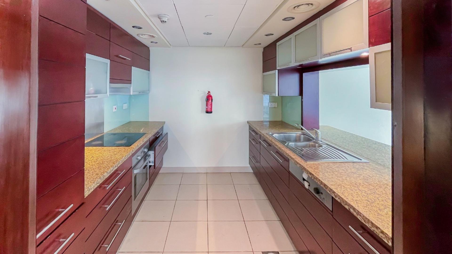 Spacious living area with large windows and terrace in Downtown Dubai apartment for rent