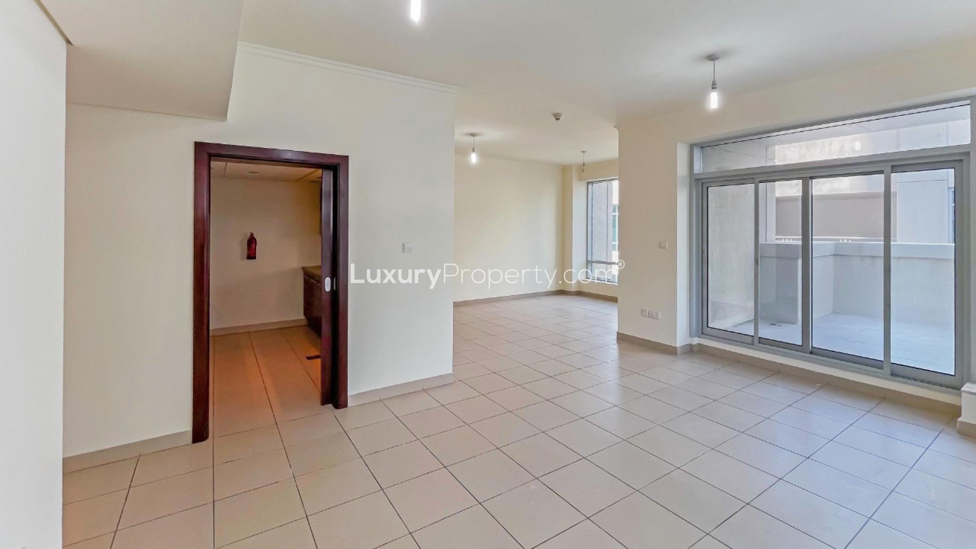 Spacious living room with large windows and terrace access in Burj Views apartment