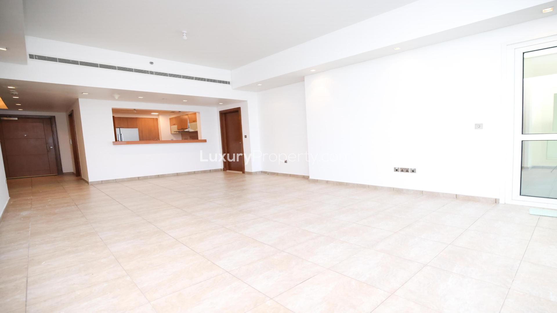 Bright living room in Marina Residences apartment, Palm Jumeirah, with large windows and tiled floor