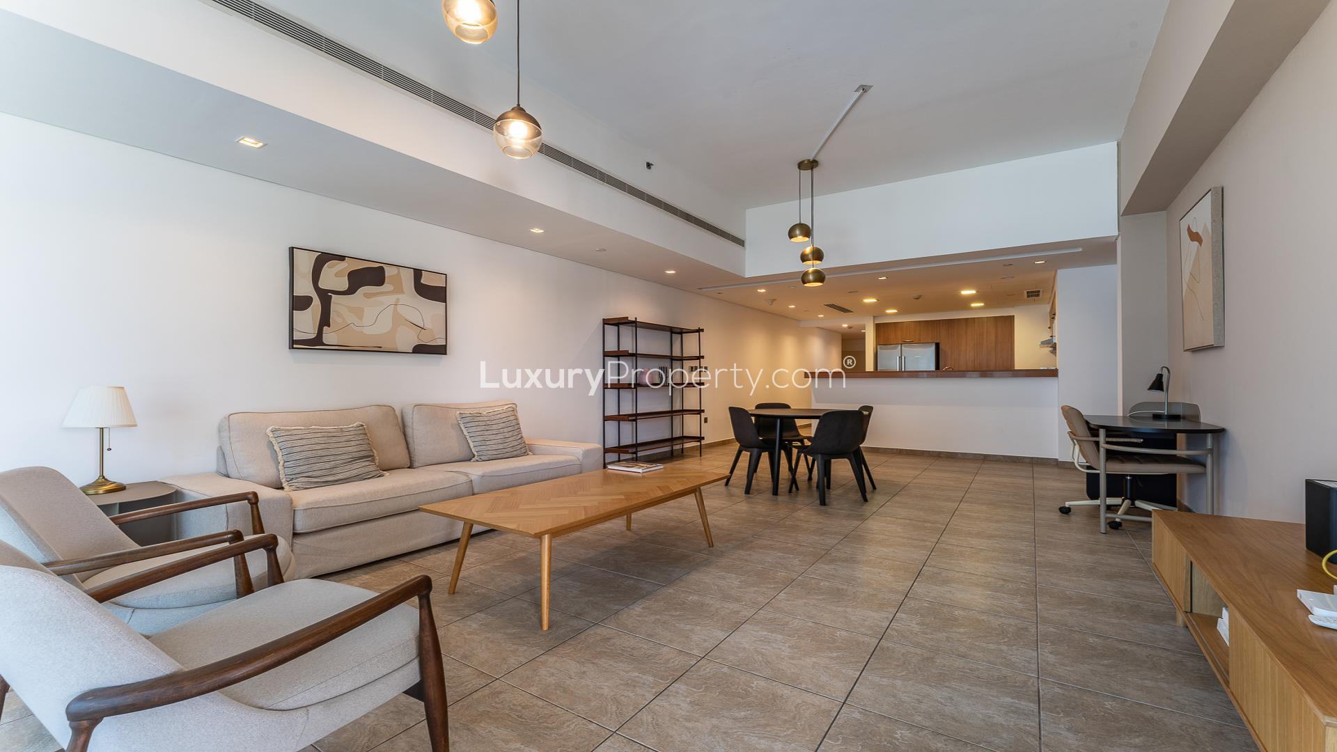 "Scenic view from Marina Residences apartment balcony overlooking Palm Jumeirah waterfront and pool.",Modern living room in Marina Residences apartment, Palm Jumeirah, open layout, stylish furnishings