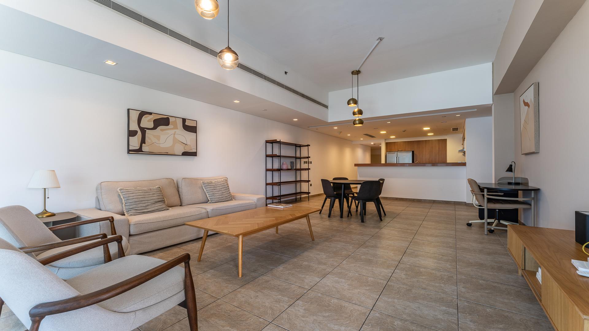 "Scenic view from Marina Residences apartment balcony overlooking Palm Jumeirah waterfront and pool.",Modern living room in Marina Residences apartment, Palm Jumeirah, open layout, stylish furnishings