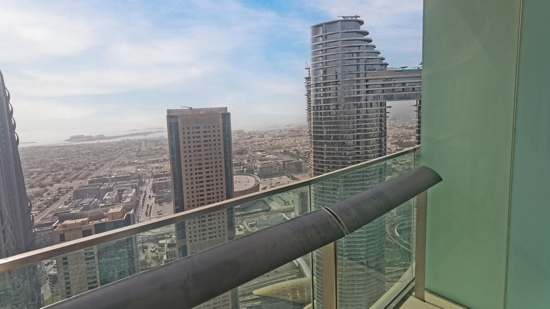 Interior view of Burj Vista apartment with cityscape through large windows, Downtown Dubai