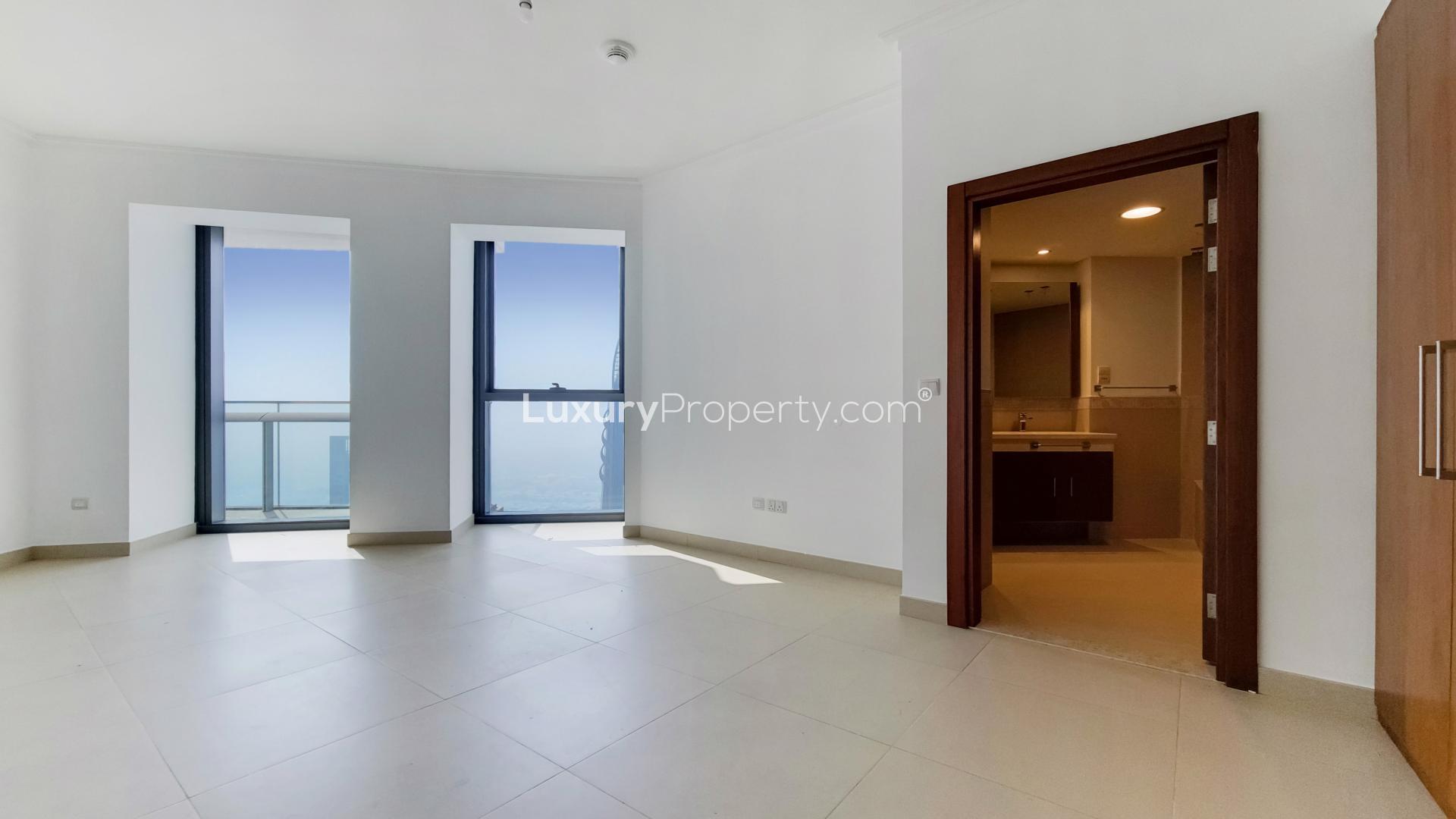 Spacious living room with large windows in high-floor Burj Vista apartment, Downtown Dubai