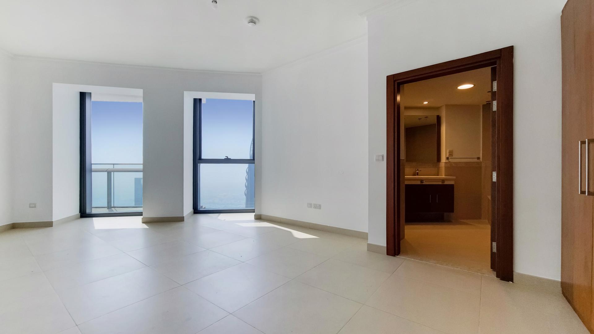 Spacious living room with large windows in high-floor Burj Vista apartment, Downtown Dubai