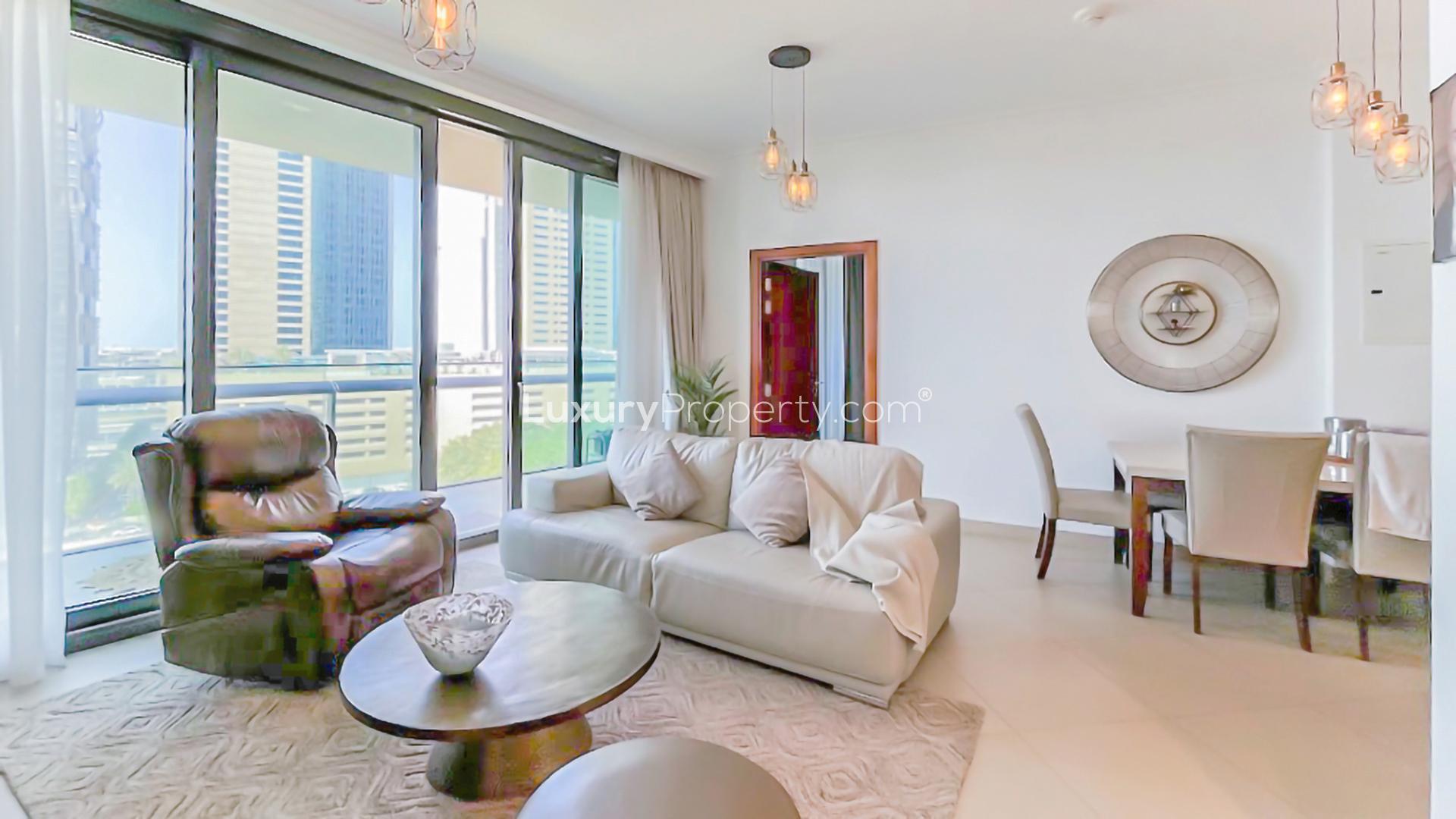 Furnished living room with large windows in Downtown Dubai apartment, Burj Vista