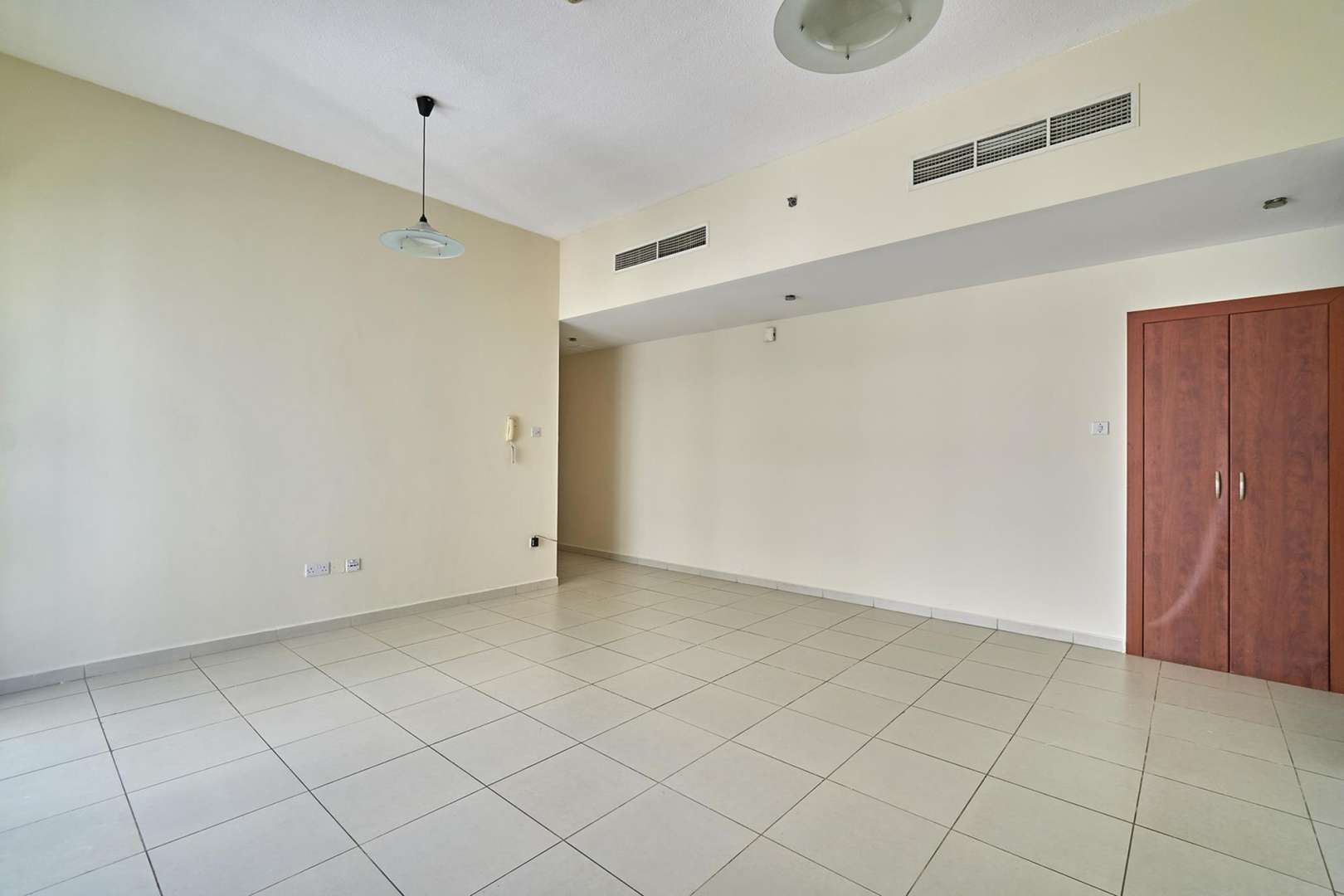Empty living room with large window in Cascades Tower, Dubai Marina apartment for sale