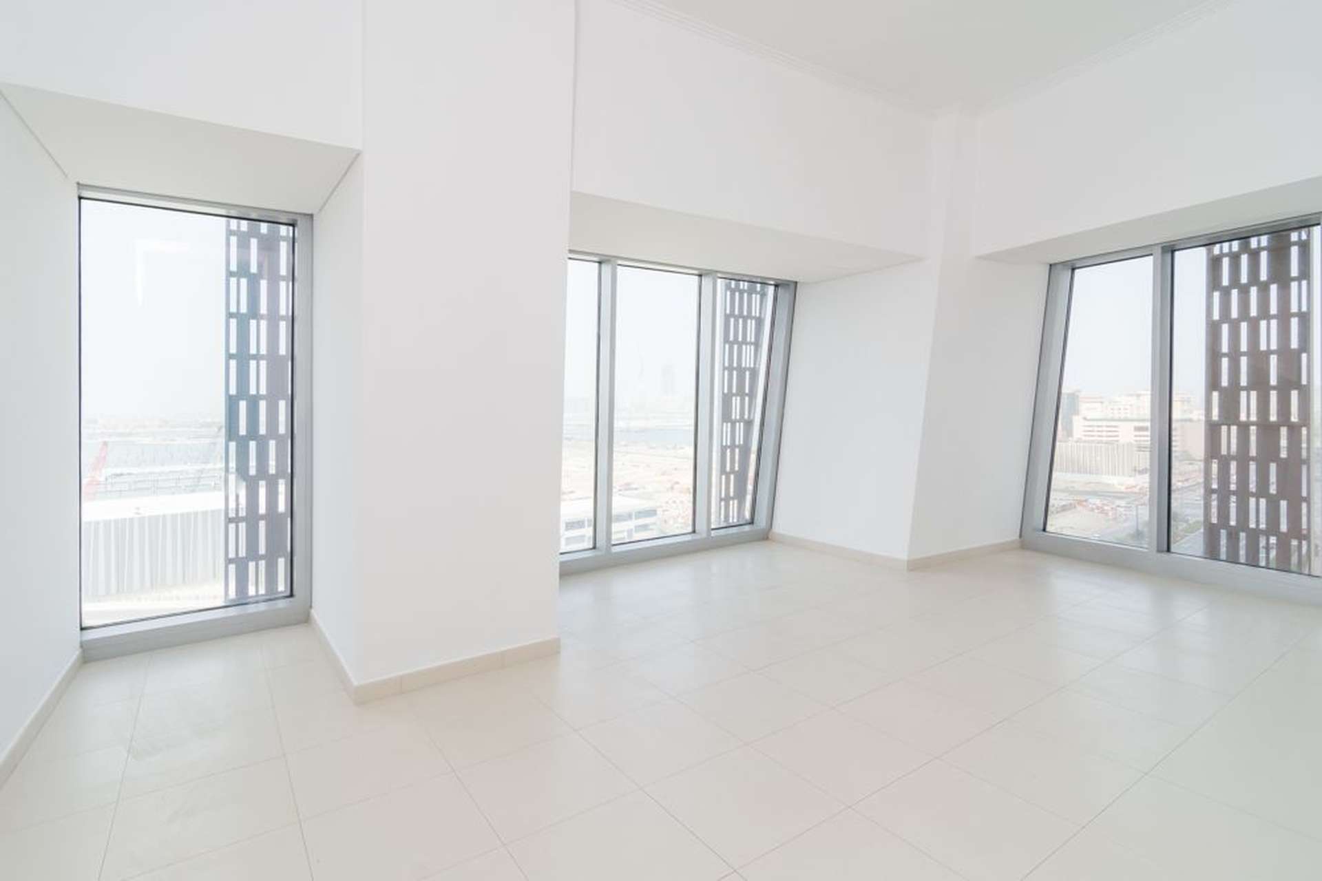 Empty bedroom with built-in wardrobe in high-floor Cayan Tower apartment, Dubai Marina