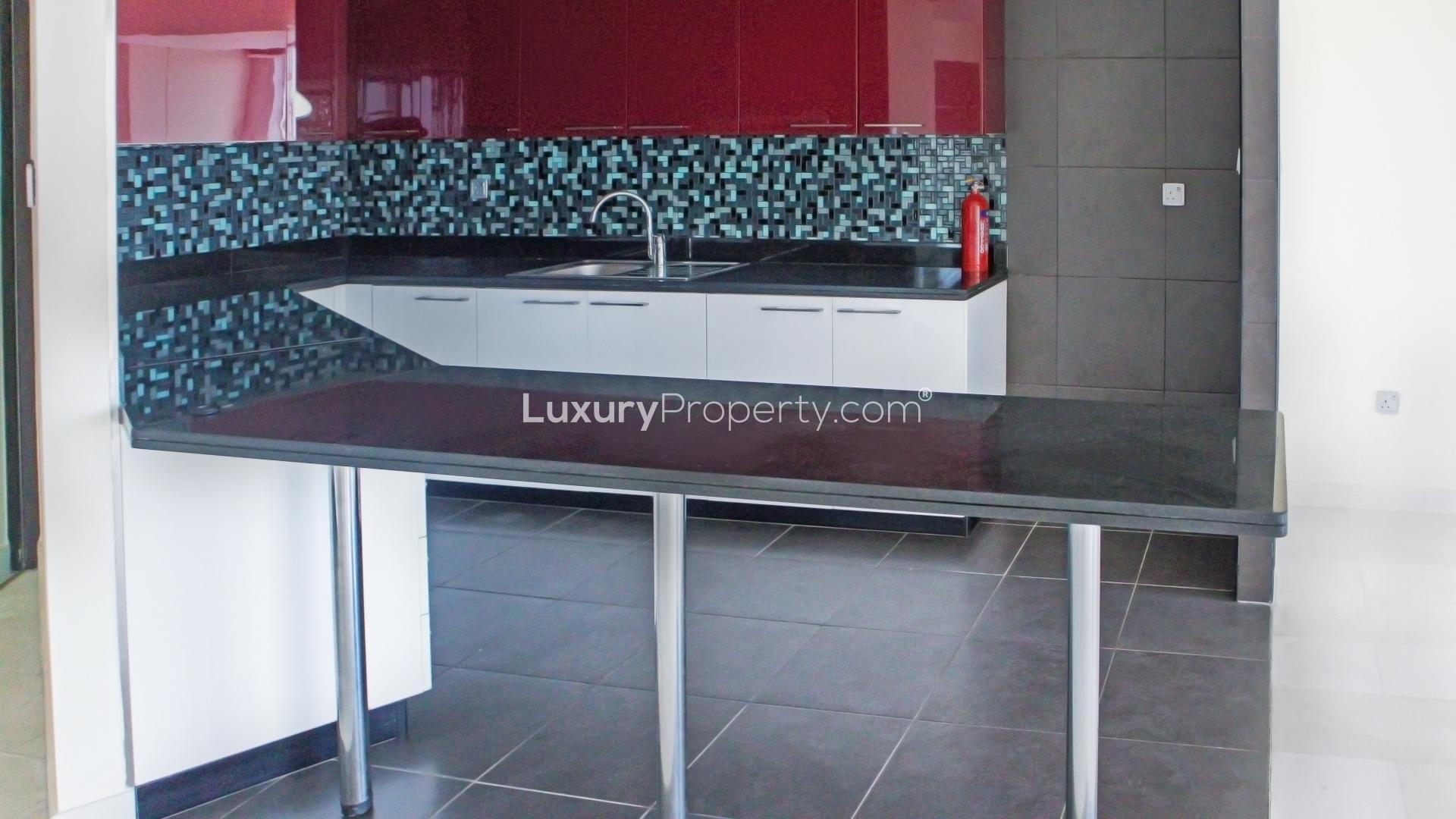 Modern kitchen in two-bedroom apartment, Cayan Tower, Dubai Marina, featuring sleek design