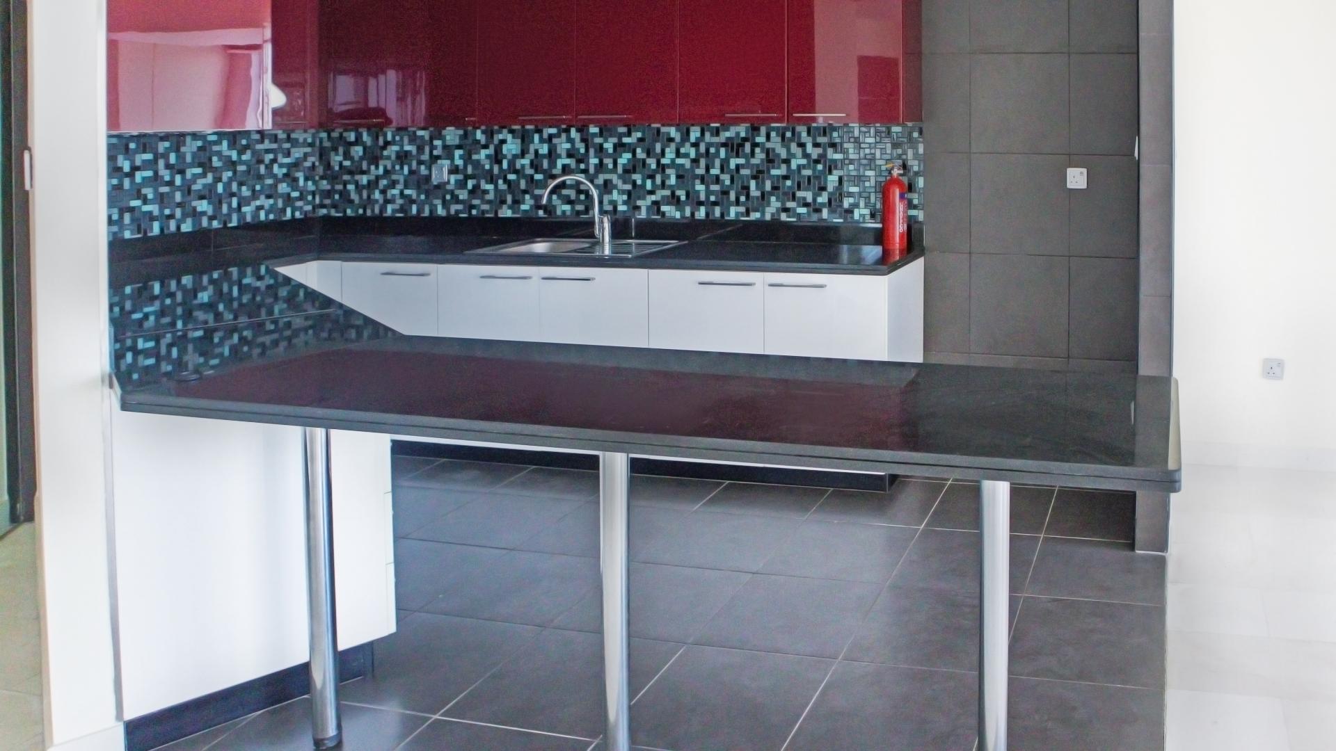 Modern kitchen in two-bedroom apartment, Cayan Tower, Dubai Marina, featuring sleek design