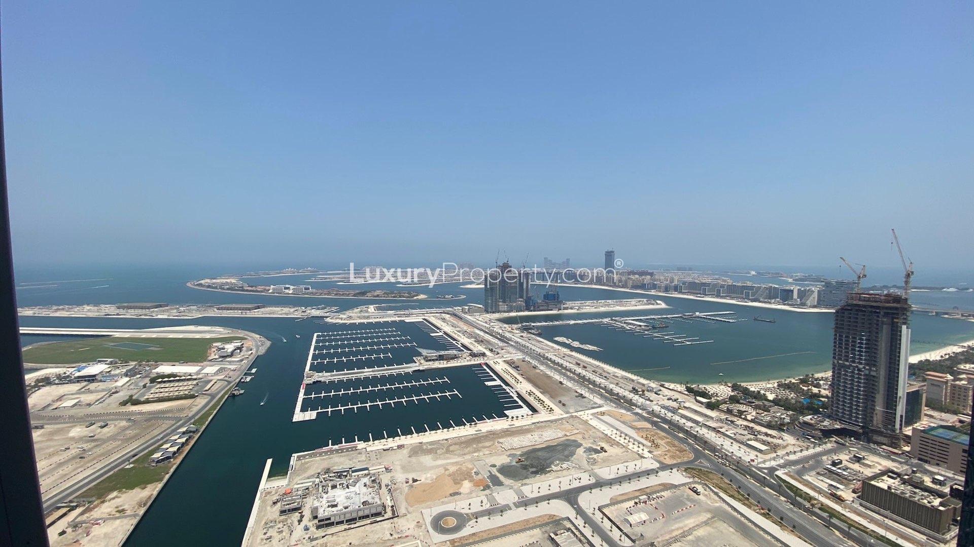 Furnished living area with modern kitchen in Cayan Tower, Dubai Marina apartment for rent