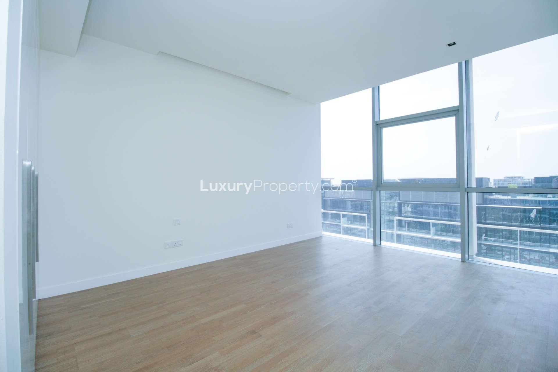 "Balcony view from 4-bedroom apartment in City Walk, Dubai, Building 25, for rent.",Bright living room with large windows in City Walk, Dubai apartment for rent