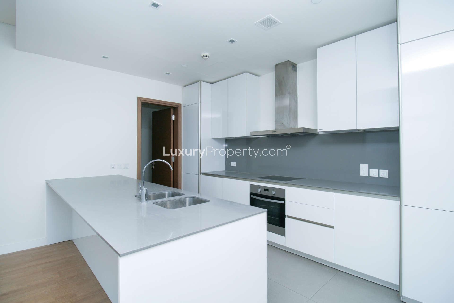 Modern kitchen in 4-bedroom apartment, City Walk, Dubai, with sleek white cabinetry