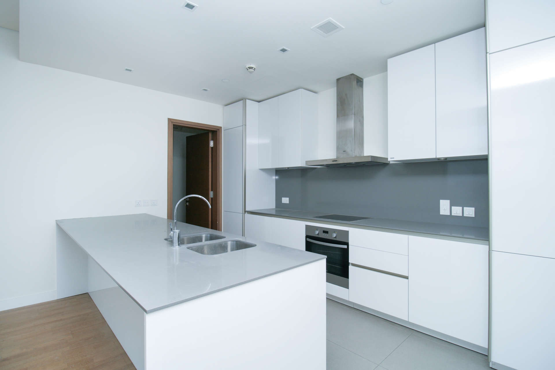 Modern kitchen in 4-bedroom apartment, City Walk, Dubai, with sleek white cabinetry