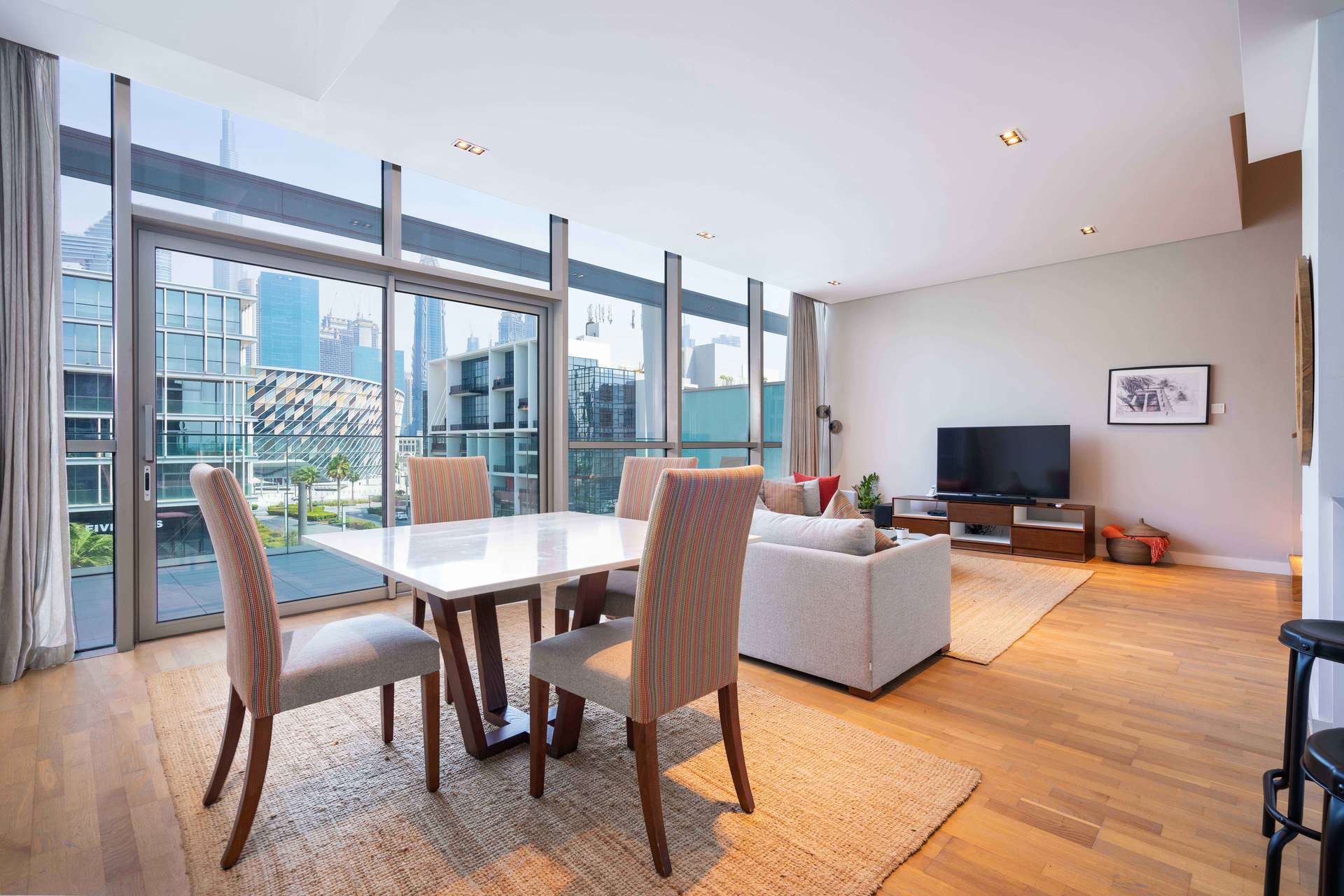 Modern living room in City Walk apartment with large windows and stylish decor