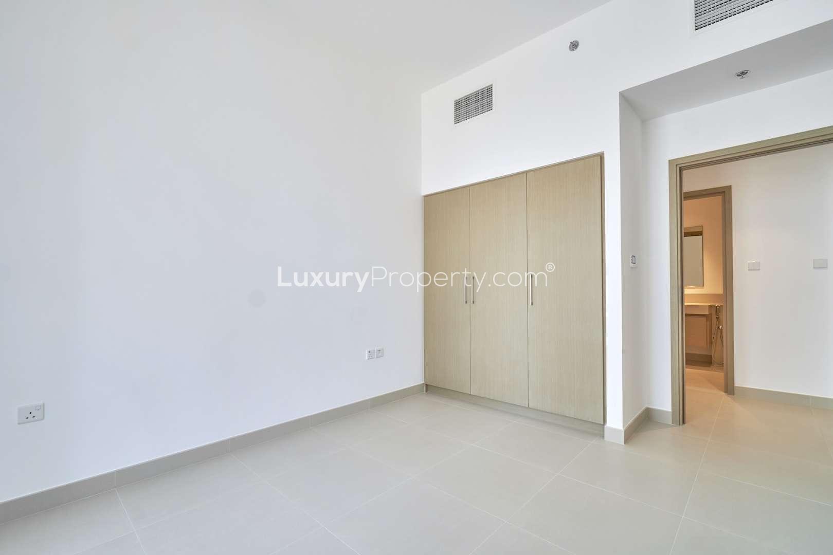 Empty bedroom with built-in wardrobe in Creek Horizon apartment, Dubai Creek Harbour
