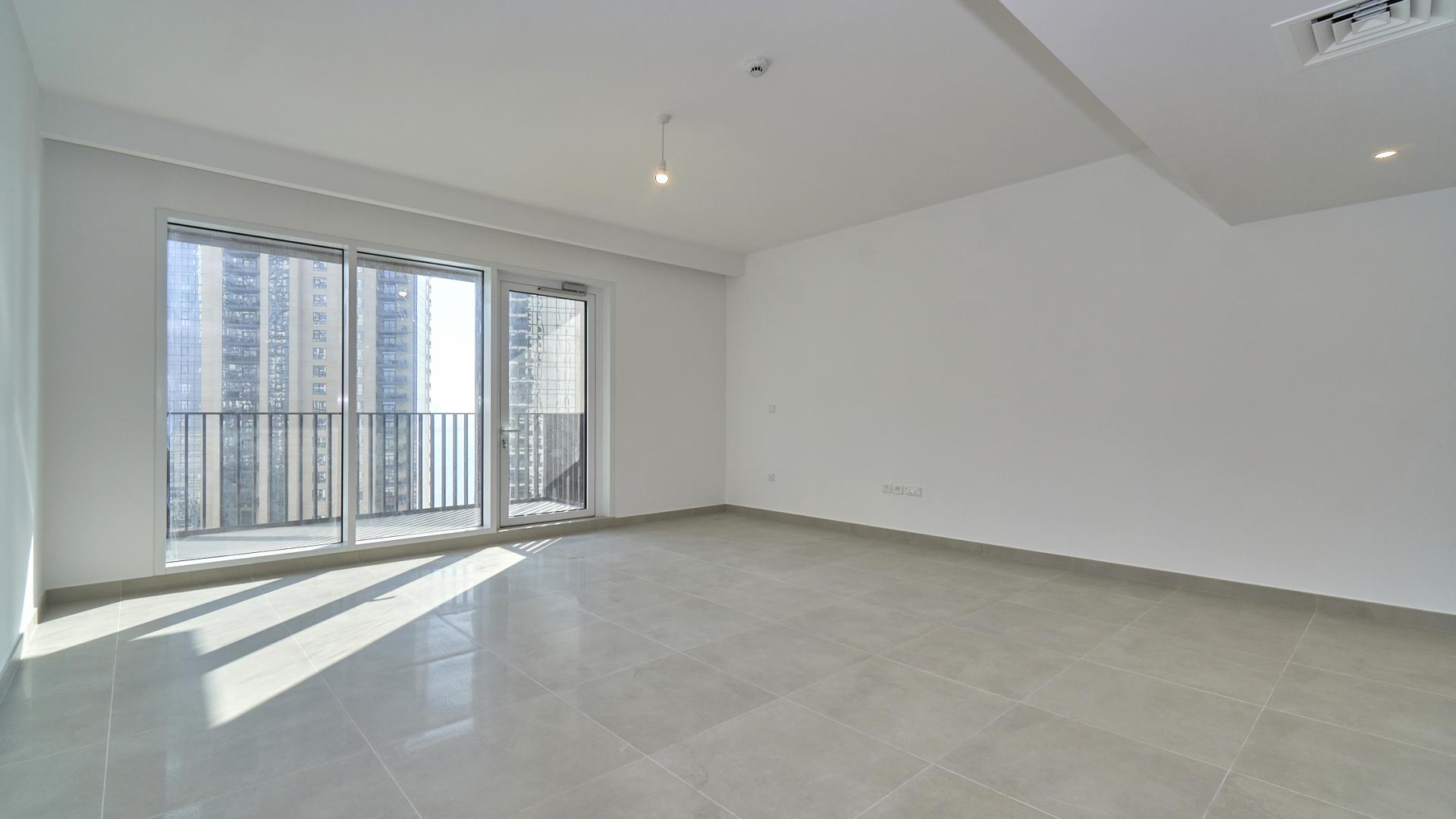 Bright living area in creek-facing apartment, Creek Horizon, with city view windows