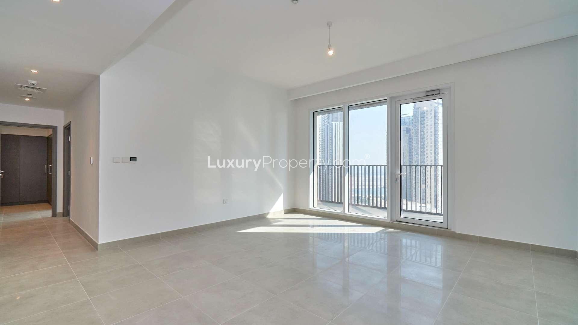 Bright living room with large windows in Creek Horizon apartment for rent