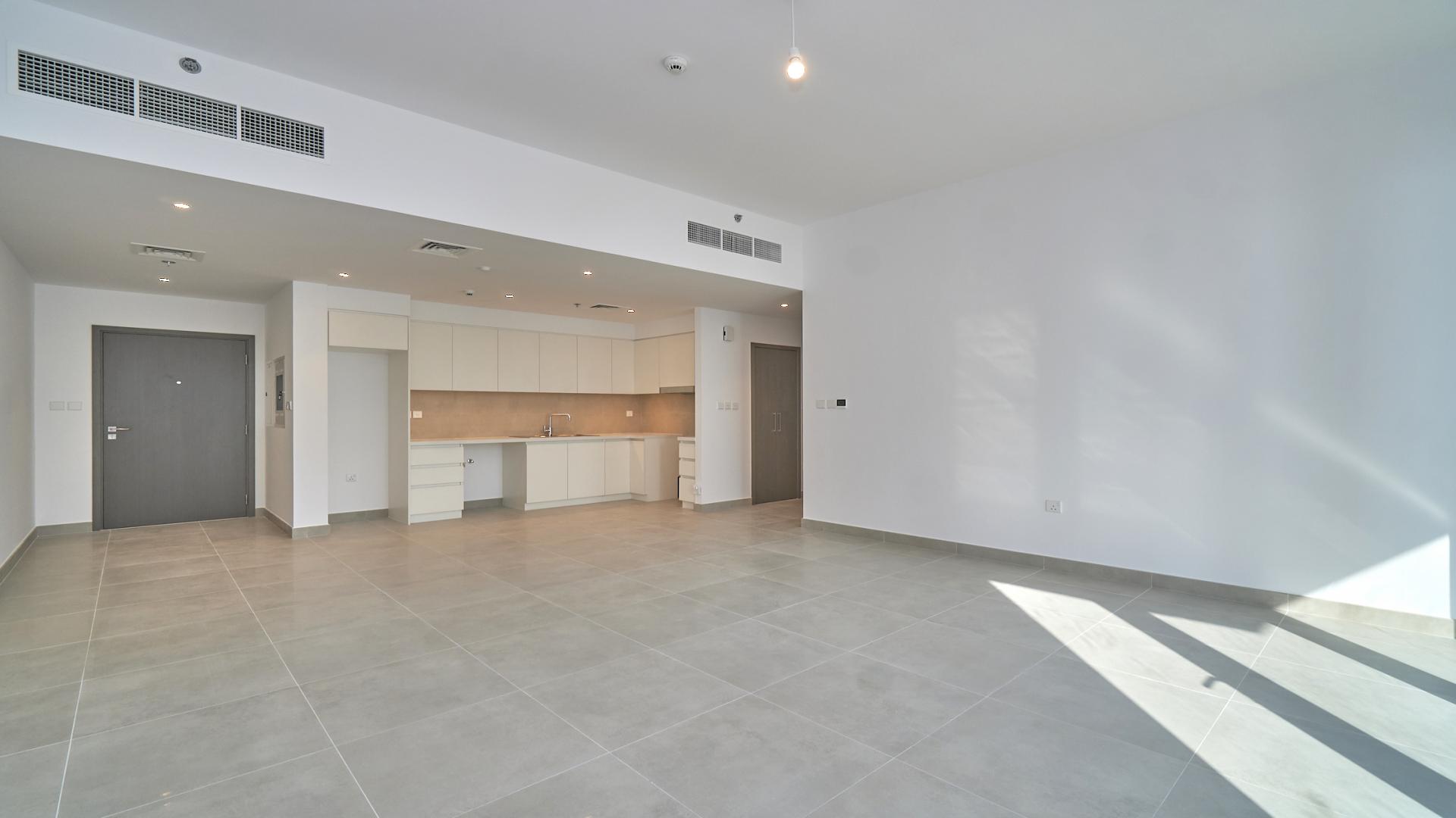 Modern living room with large windows in Creek Horizon apartment, vibrant neighborhood view