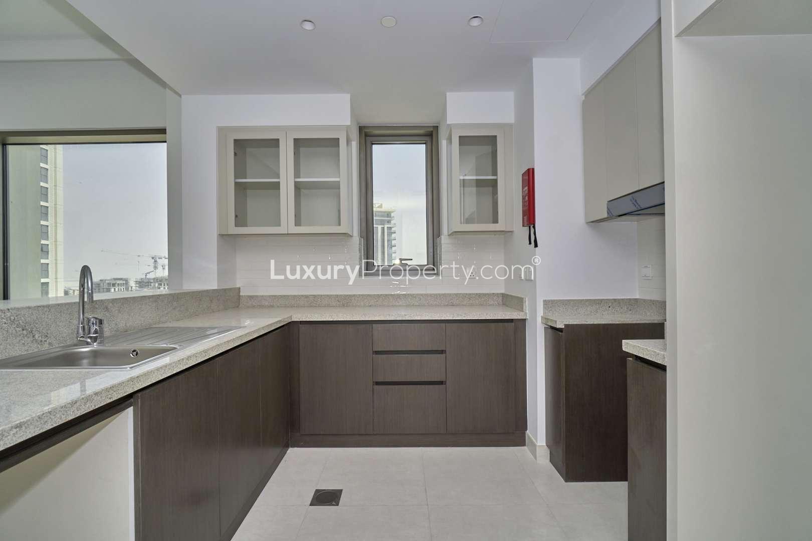 Modern kitchen with large windows in Dubai Creek Harbour apartment for rent