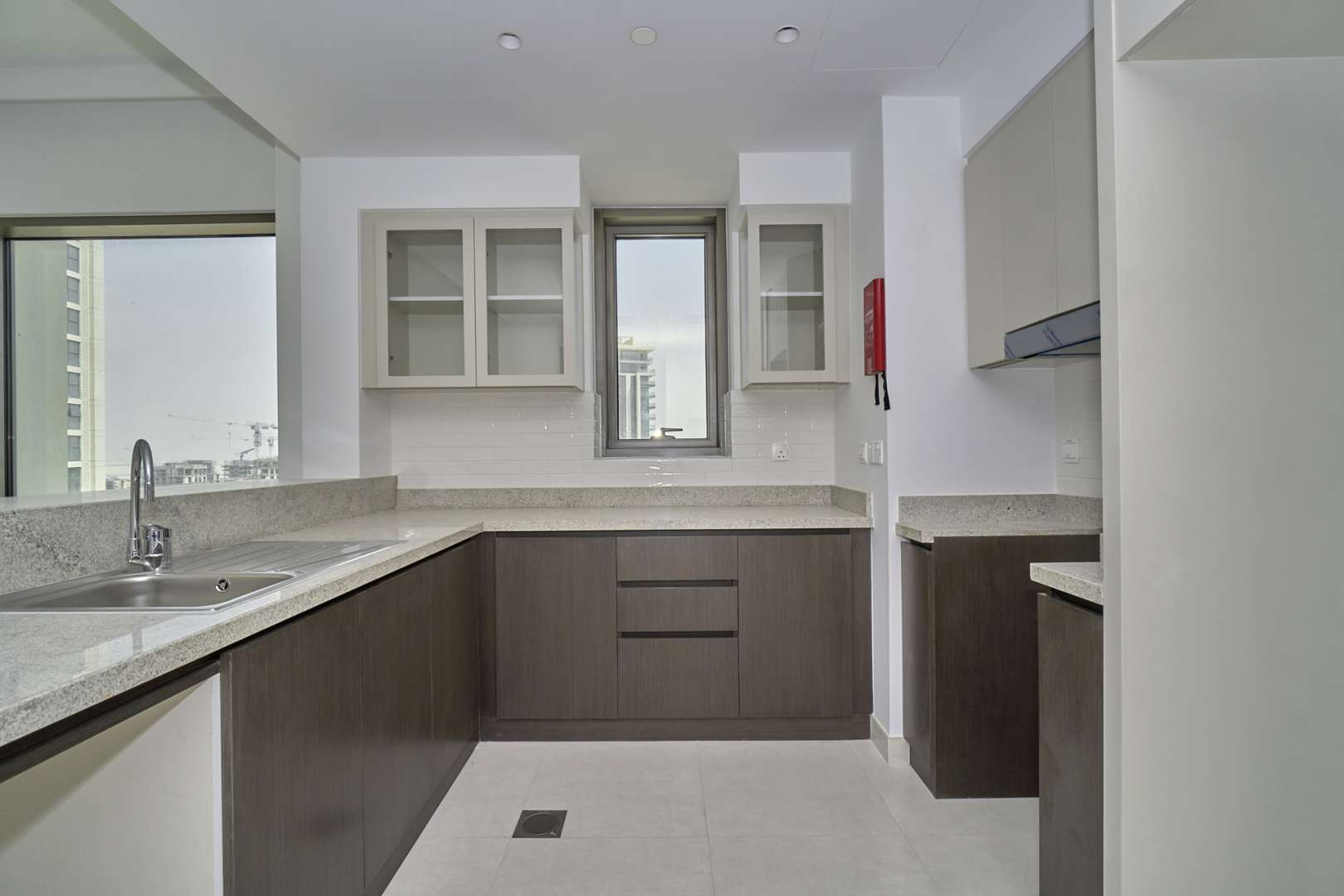 Modern kitchen with large windows in Dubai Creek Harbour apartment for rent