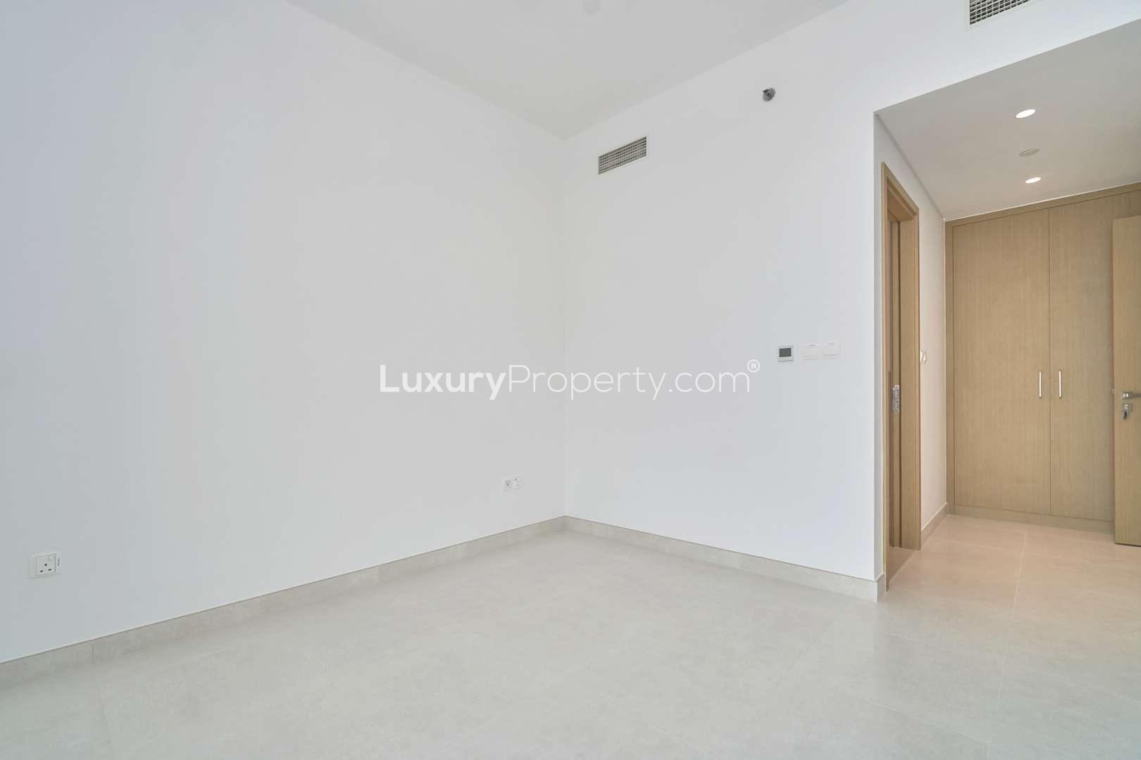 Empty room with large window in Creekside 18 apartment, Dubai Creek Harbour