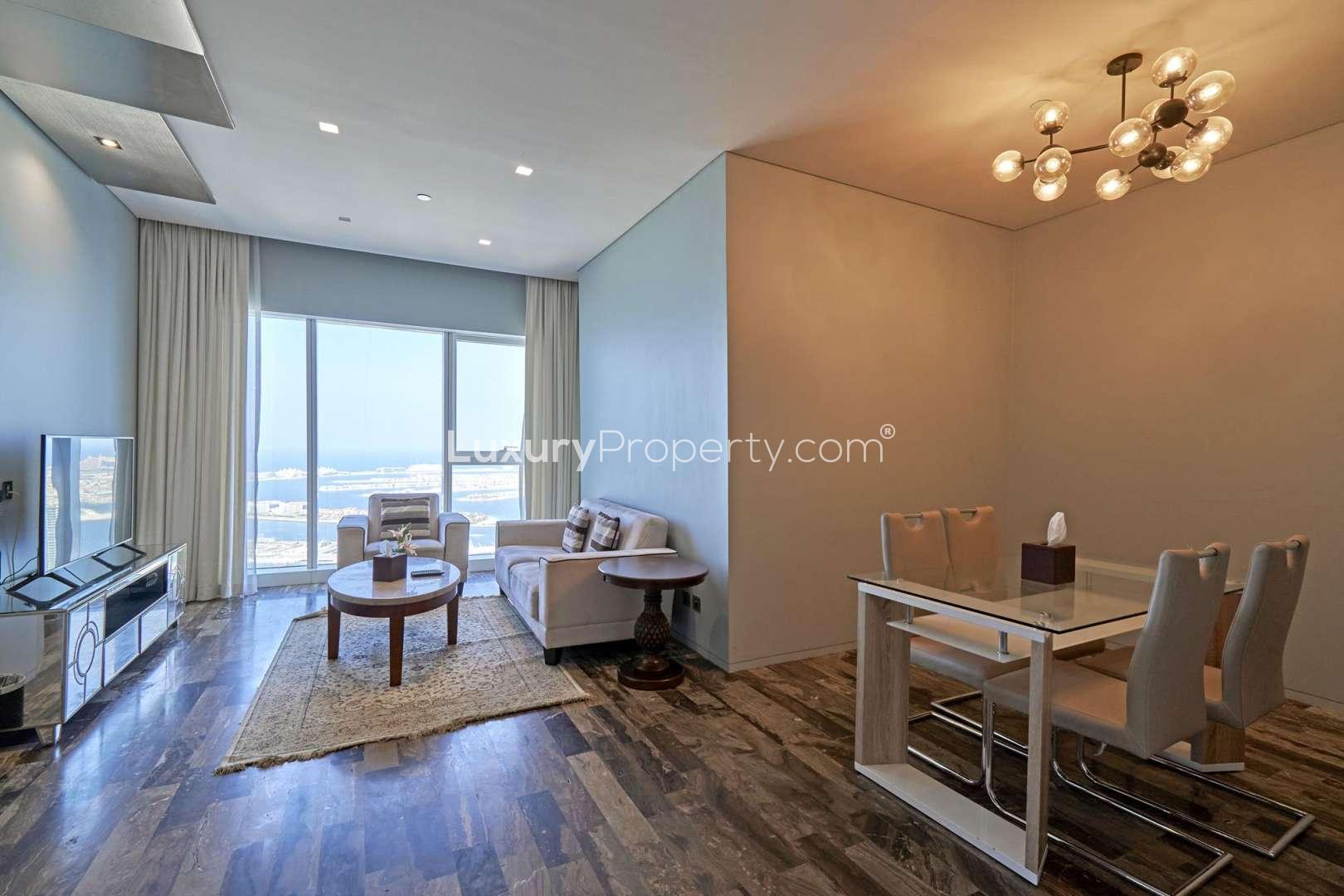 "Stunning sea view from Fendi apartment in DAMAC Residenze, Dubai Marina, high-floor perspective.",Luxurious living room in Fendi apartment, DAMAC Residenze, Dubai Marina, with sea view