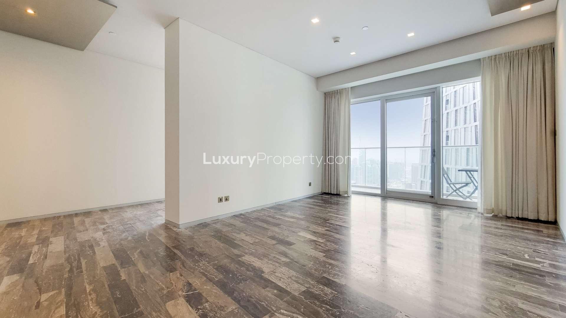 "Balcony view from 2-bedroom apartment in Damac Heights, Dubai Marina, overlooking cityscape.",Empty living room with sea view balcony in Damac Heights, Dubai Marina apartment