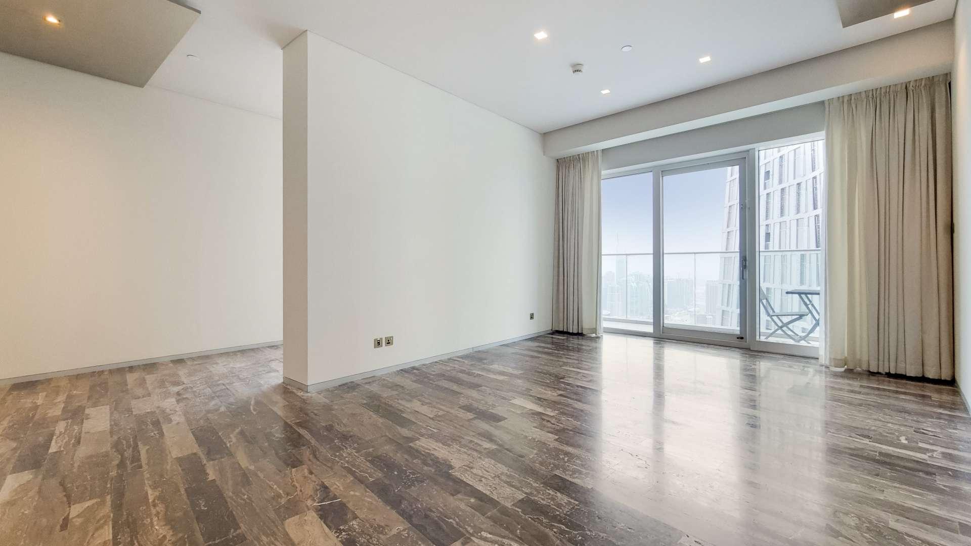 "Balcony view from 2-bedroom apartment in Damac Heights, Dubai Marina, overlooking cityscape.",Empty living room with sea view balcony in Damac Heights, Dubai Marina apartment