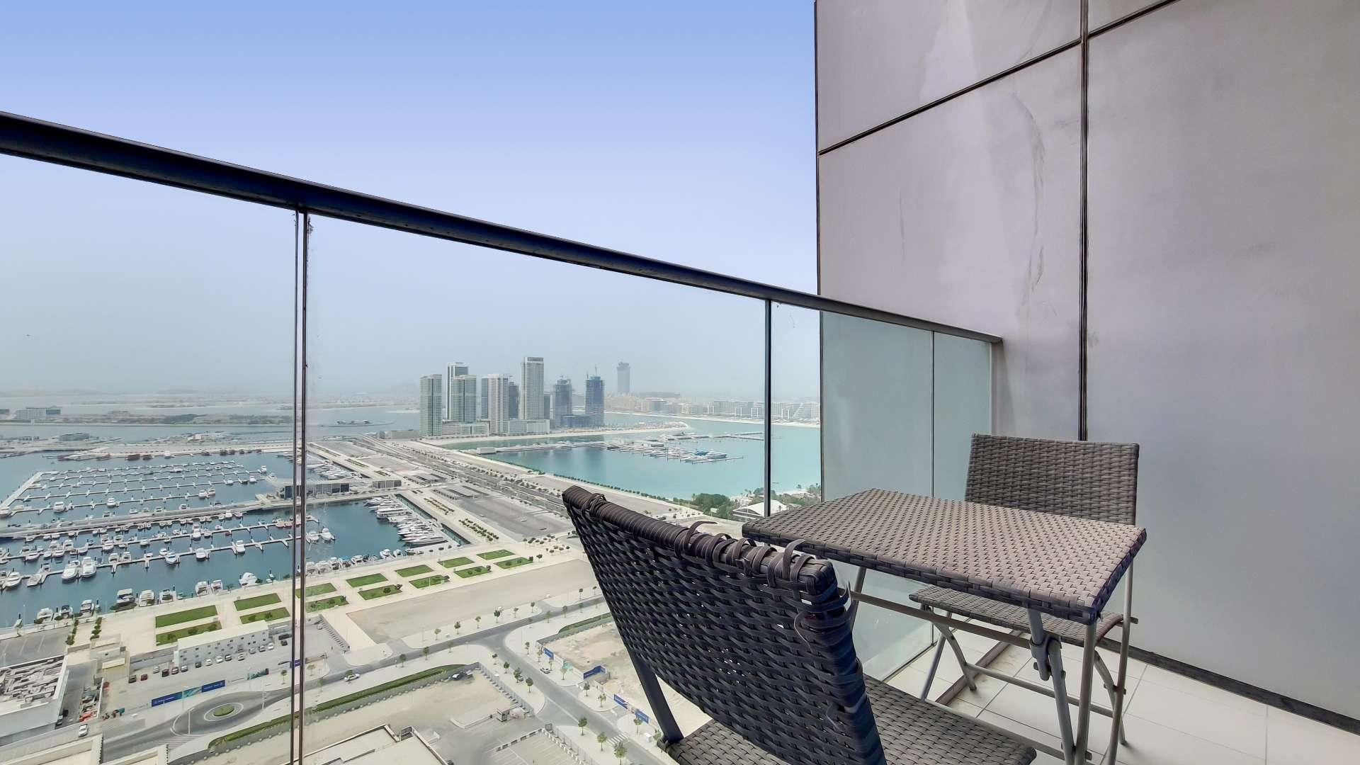 Aerial view of marina with yachts, skyscrapers in Dubai Marina, near Damac Heights apartment