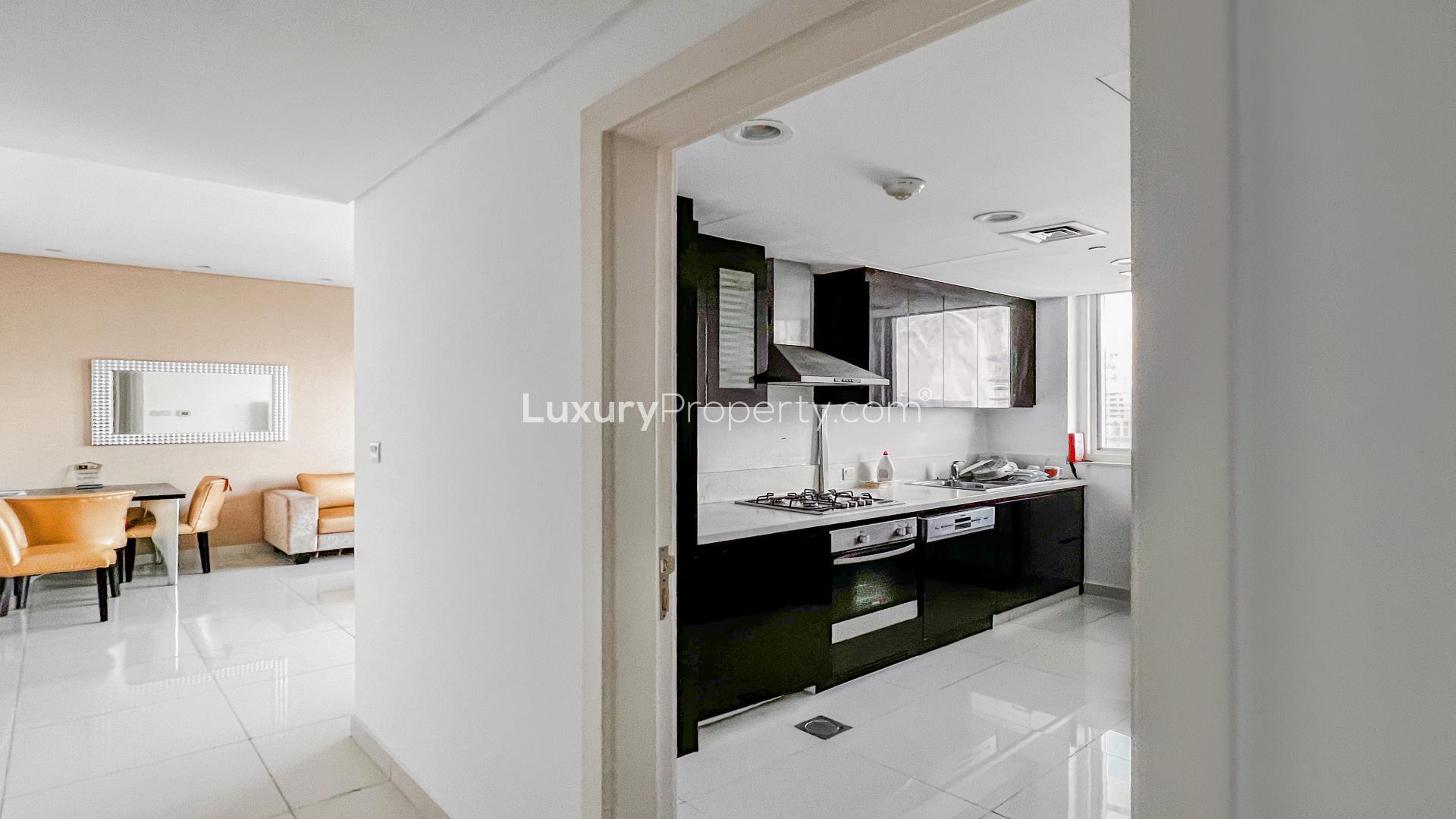 Modern living room in furnished Business Bay apartment, featuring sleek decor and TV unit