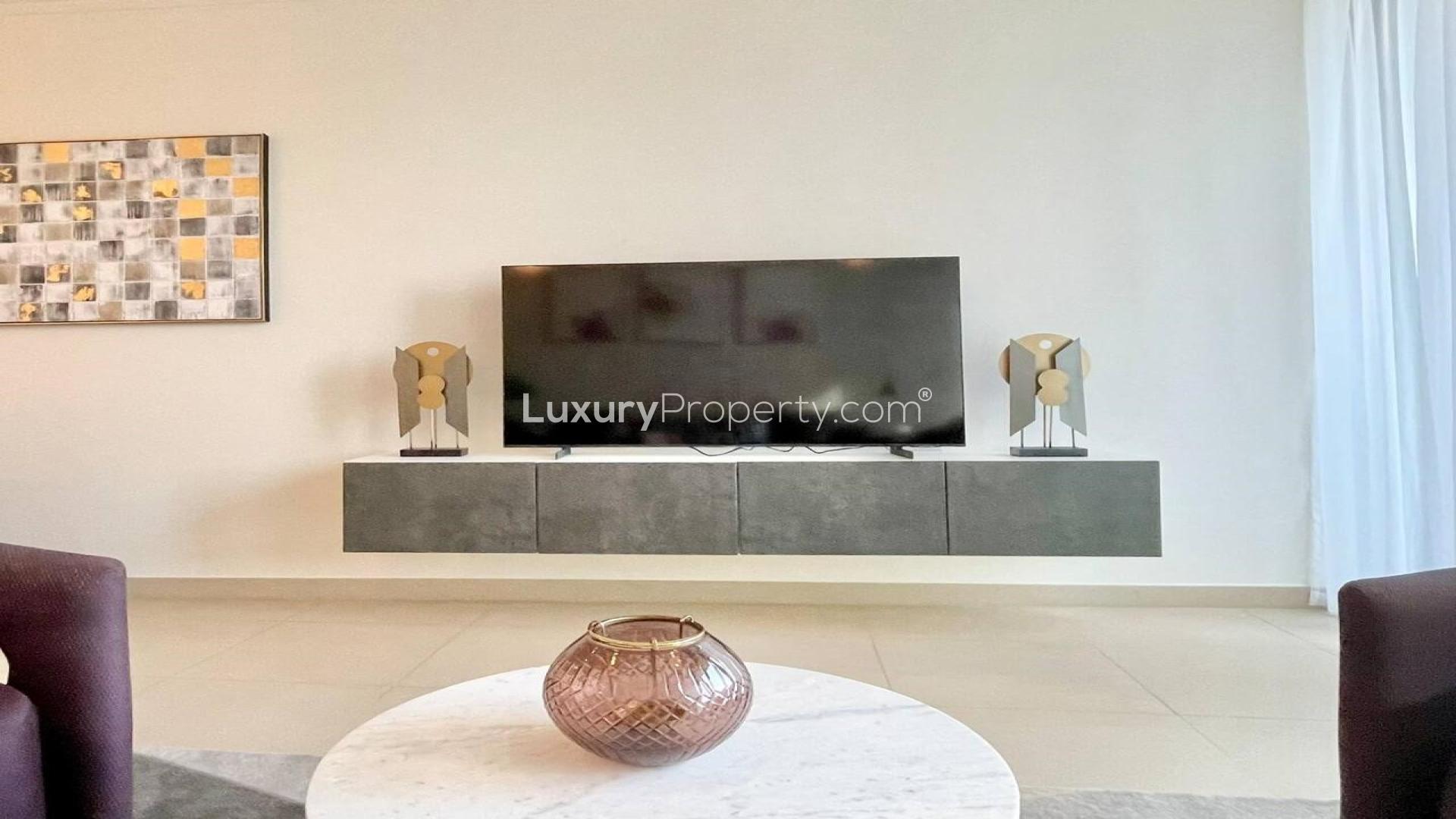 Furnished living room in Downtown Dubai apartment with modern decor and natural light