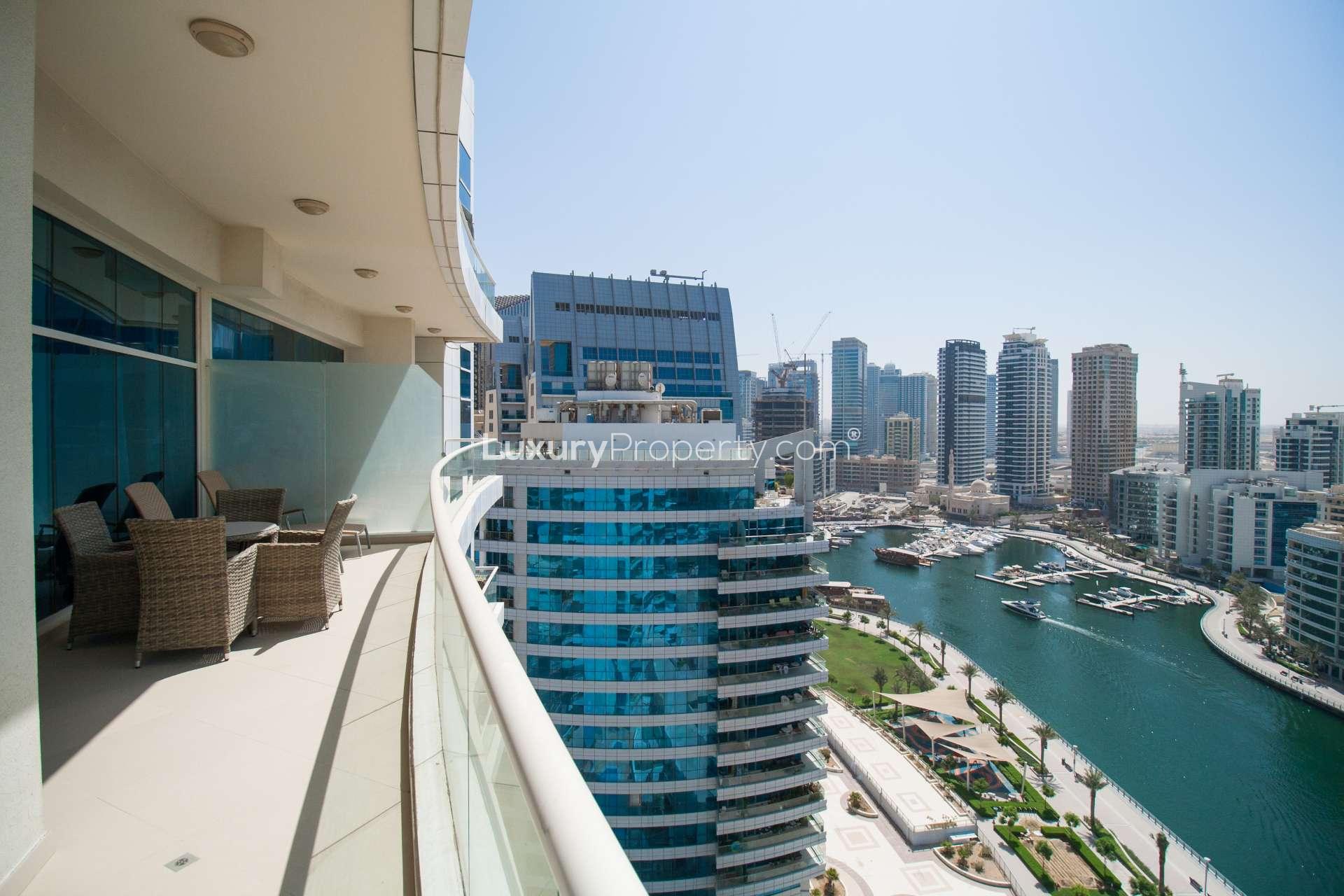 Outdoor pool area at Dorra Bay apartment, Dubai Marina, surrounded by modern buildings