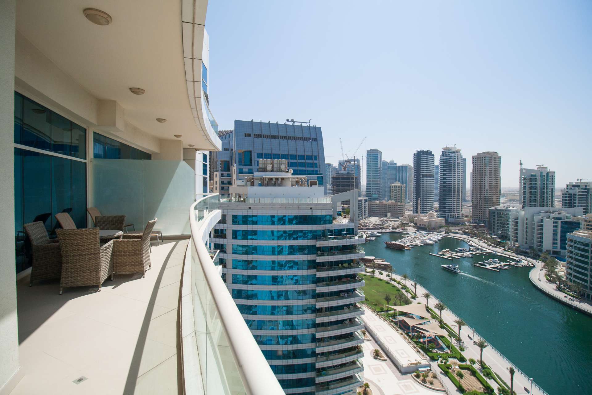 Outdoor pool area at Dorra Bay apartment, Dubai Marina, surrounded by modern buildings