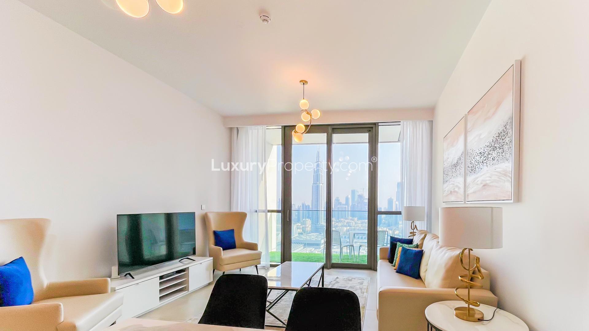 Furnished living room in two-bed Downtown Views apartment, featuring modern decor and city views