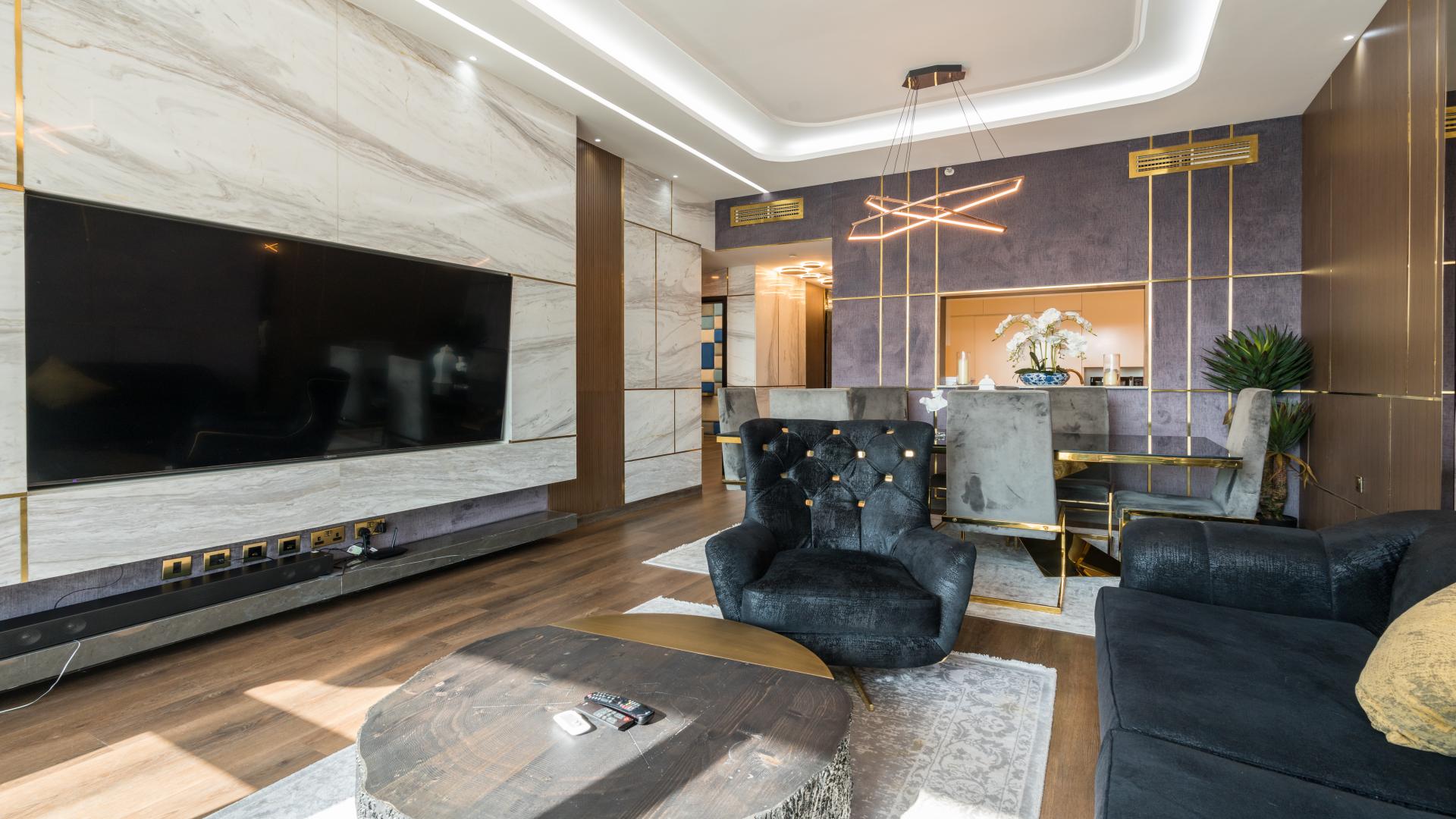 Luxurious furnished living room in Downtown Dubai apartment with modern decor and elegant finishes