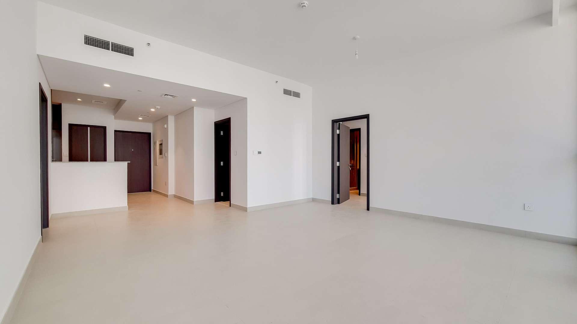 Empty apartment room with large windows showcasing Downtown Dubai city views