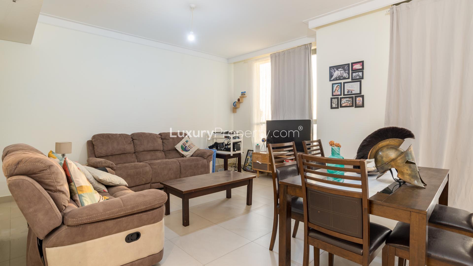 Contemporary apartment living room with desk, chair, and natural light in Dubai Creek