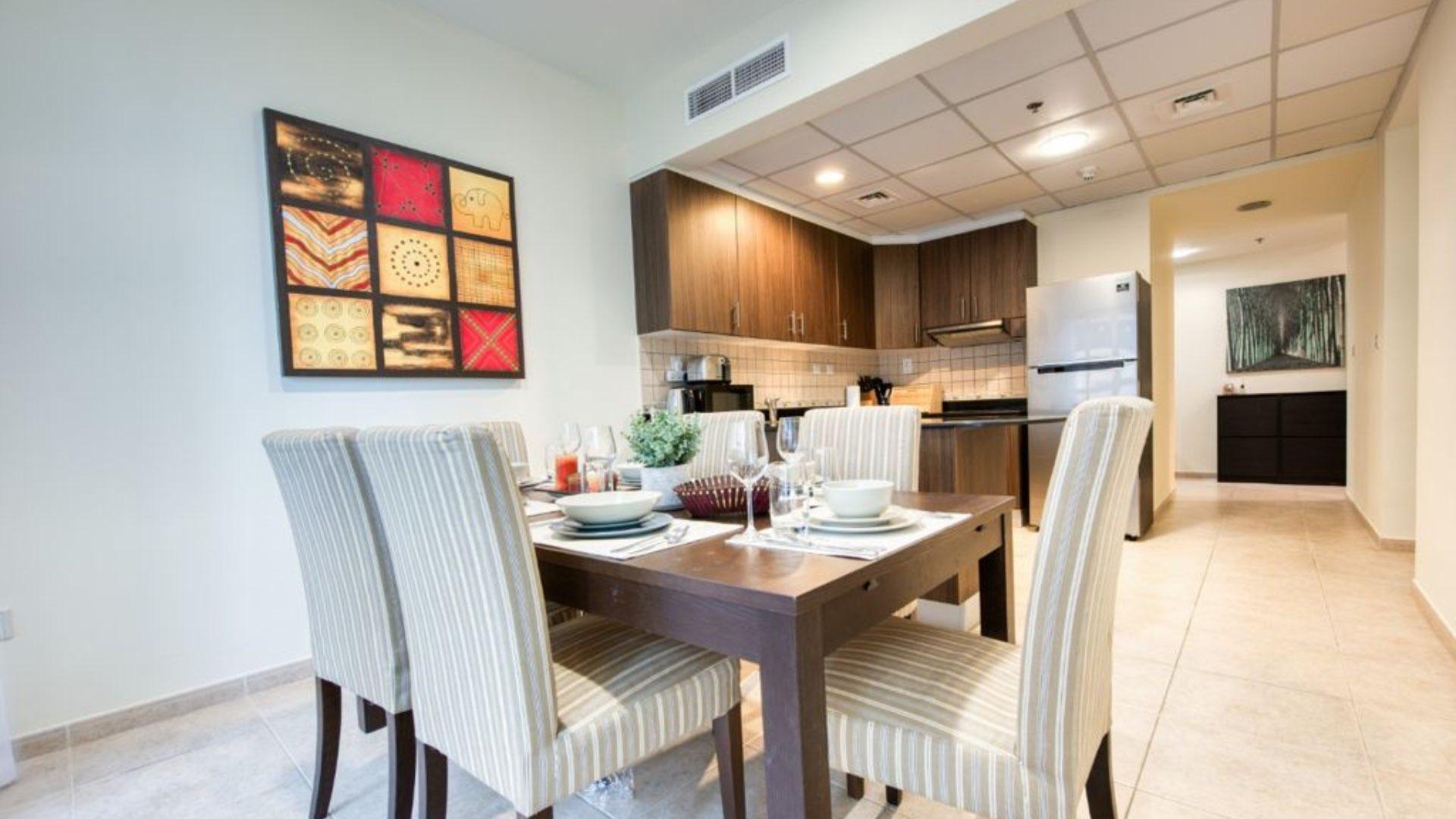 Modern living room in high-rise Dubai Marina apartment with stylish decor and large window views