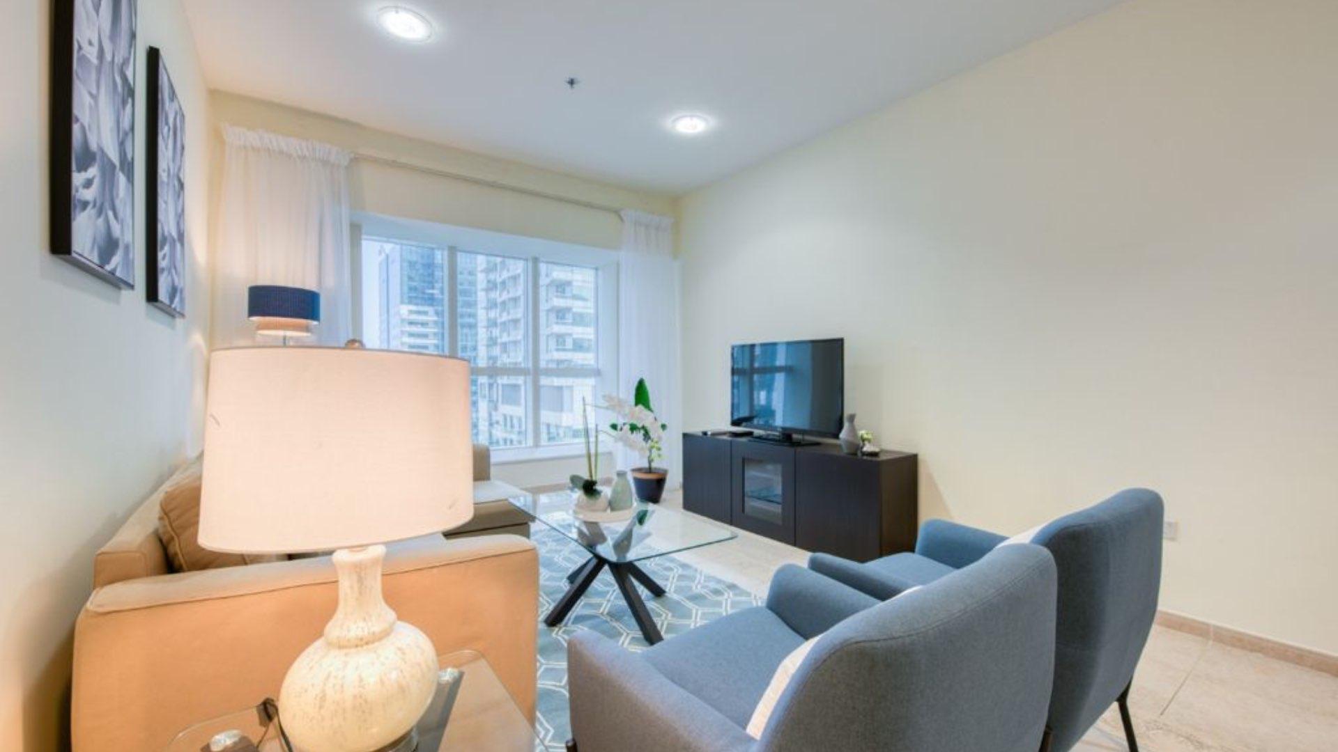 Elegant living room in 2-bedroom Dubai Marina apartment, featuring modern decor and cozy seating