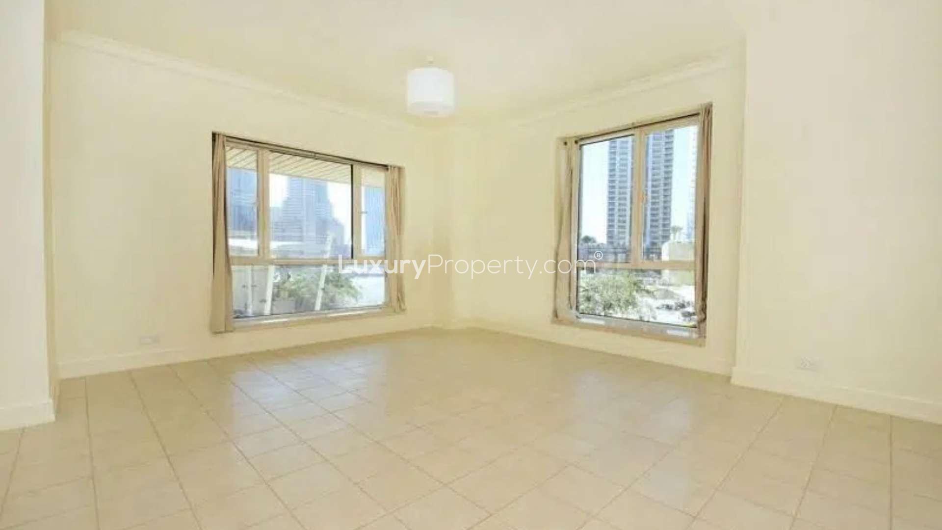 View of Dubai Marina skyline from Emaar 6 Towers apartment balcony, palm trees visible