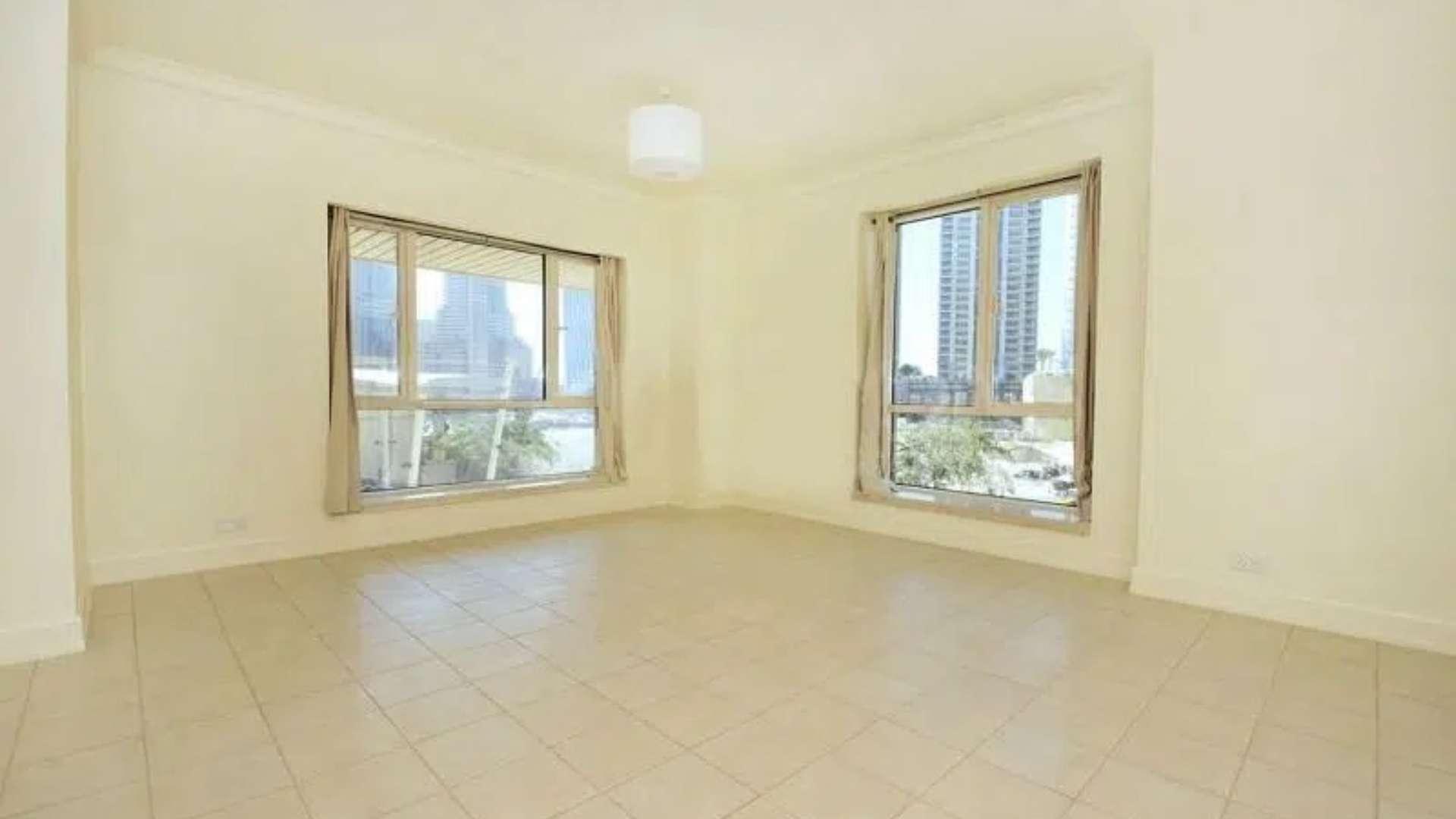 View of Dubai Marina skyline from Emaar 6 Towers apartment balcony, palm trees visible