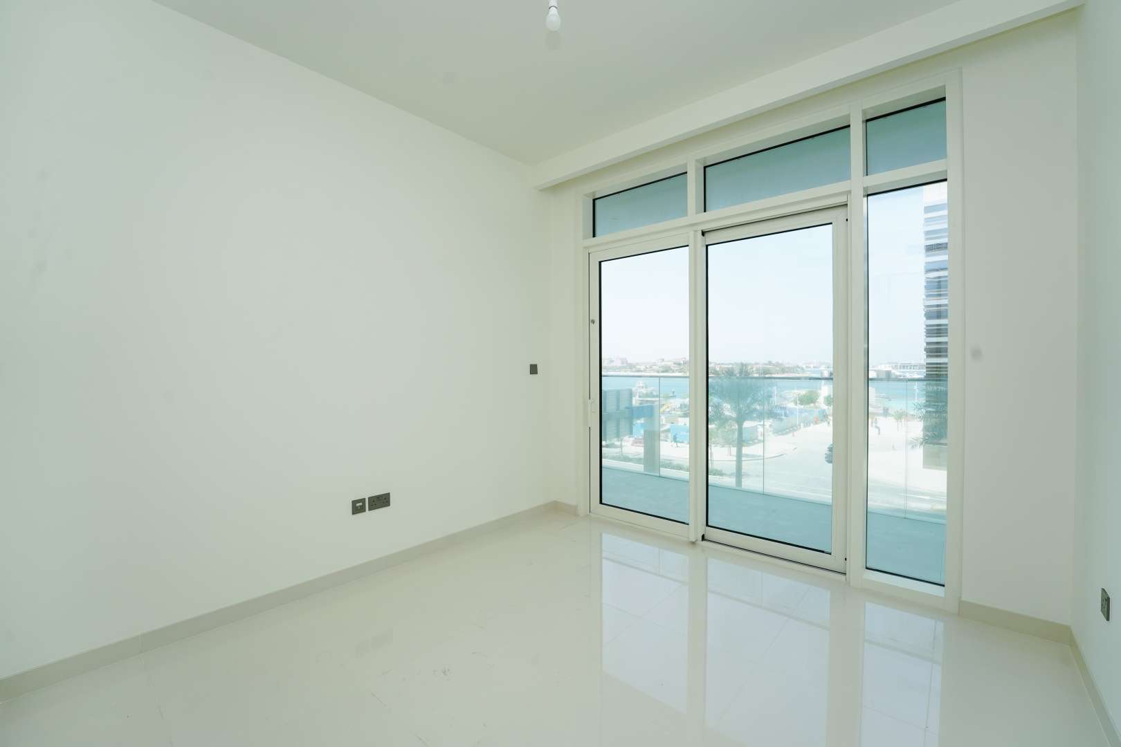 Empty bedroom in luxury apartment, Emaar Beachfront, Dubai Harbour, featuring modern built-in wardrobe