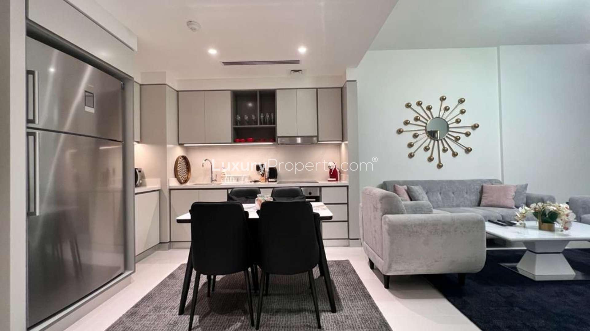 "Stunning marina view from Emaar Beachfront apartment balcony in Dubai Harbour, available for rent.",Fully furnished apartment living room and kitchen, Emaar Beachfront, Dubai Harbour