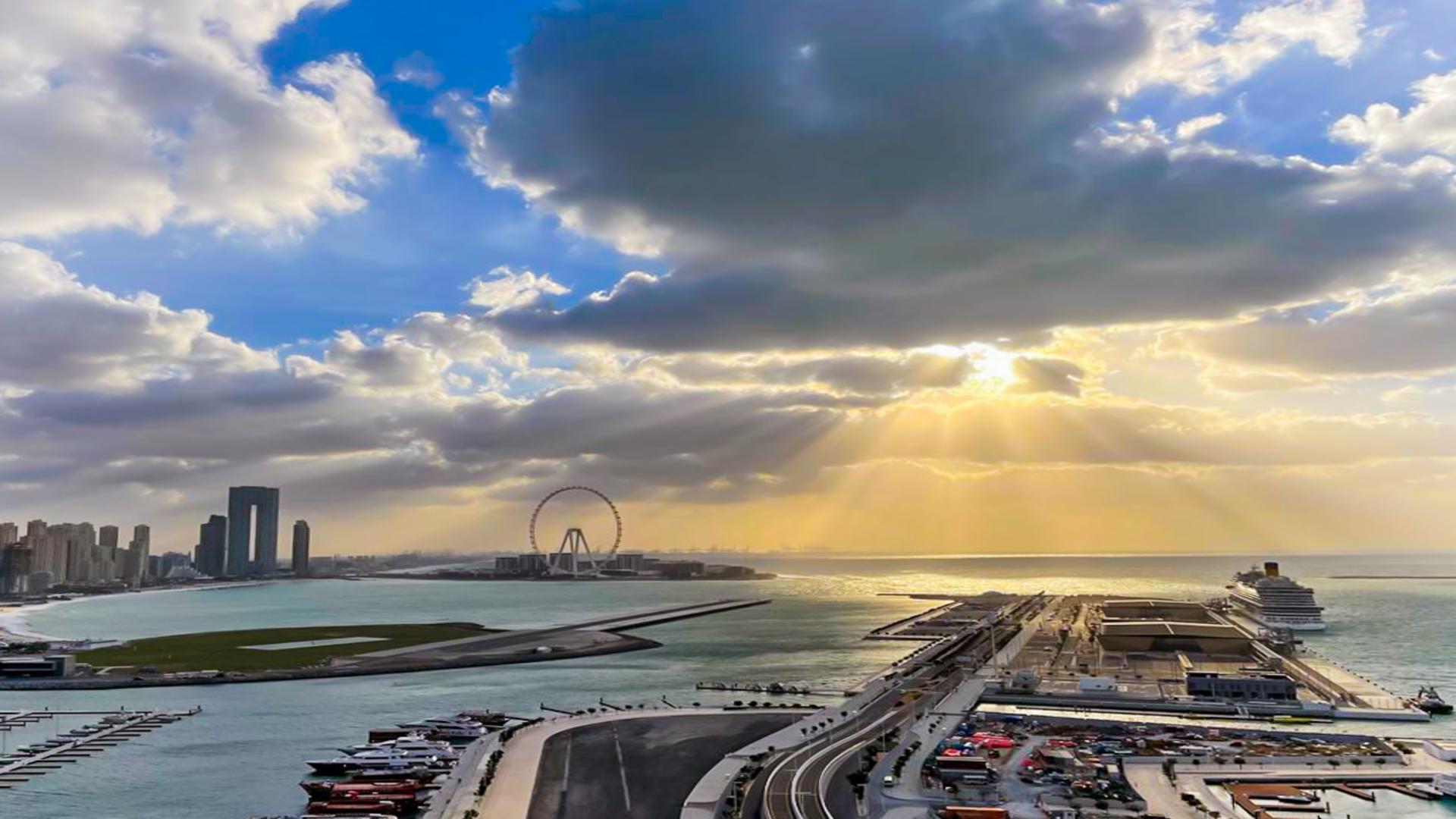 Luxury furnished living room in Sunrise Bay apartment, Dubai Harbour, with modern decor and TV