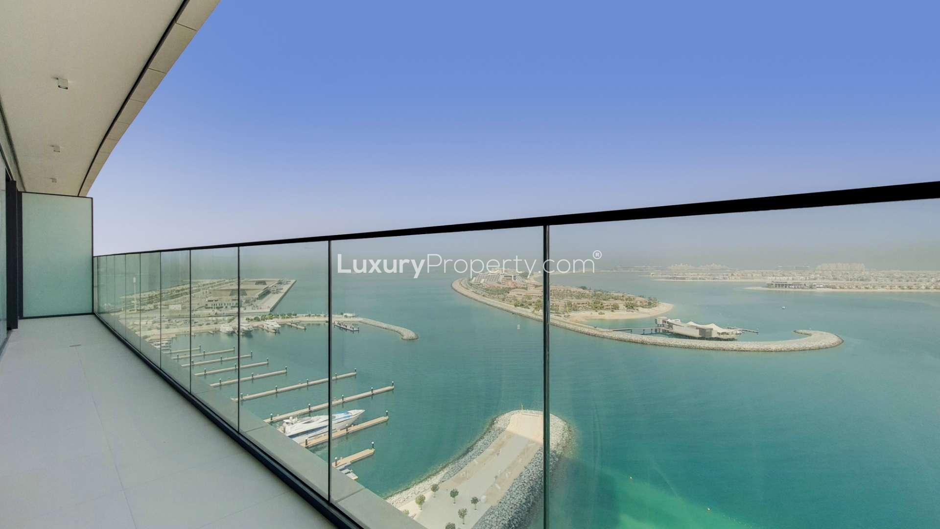Contemporary apartment balcony with expansive sea views at Emaar Beachfront, Dubai Harbour