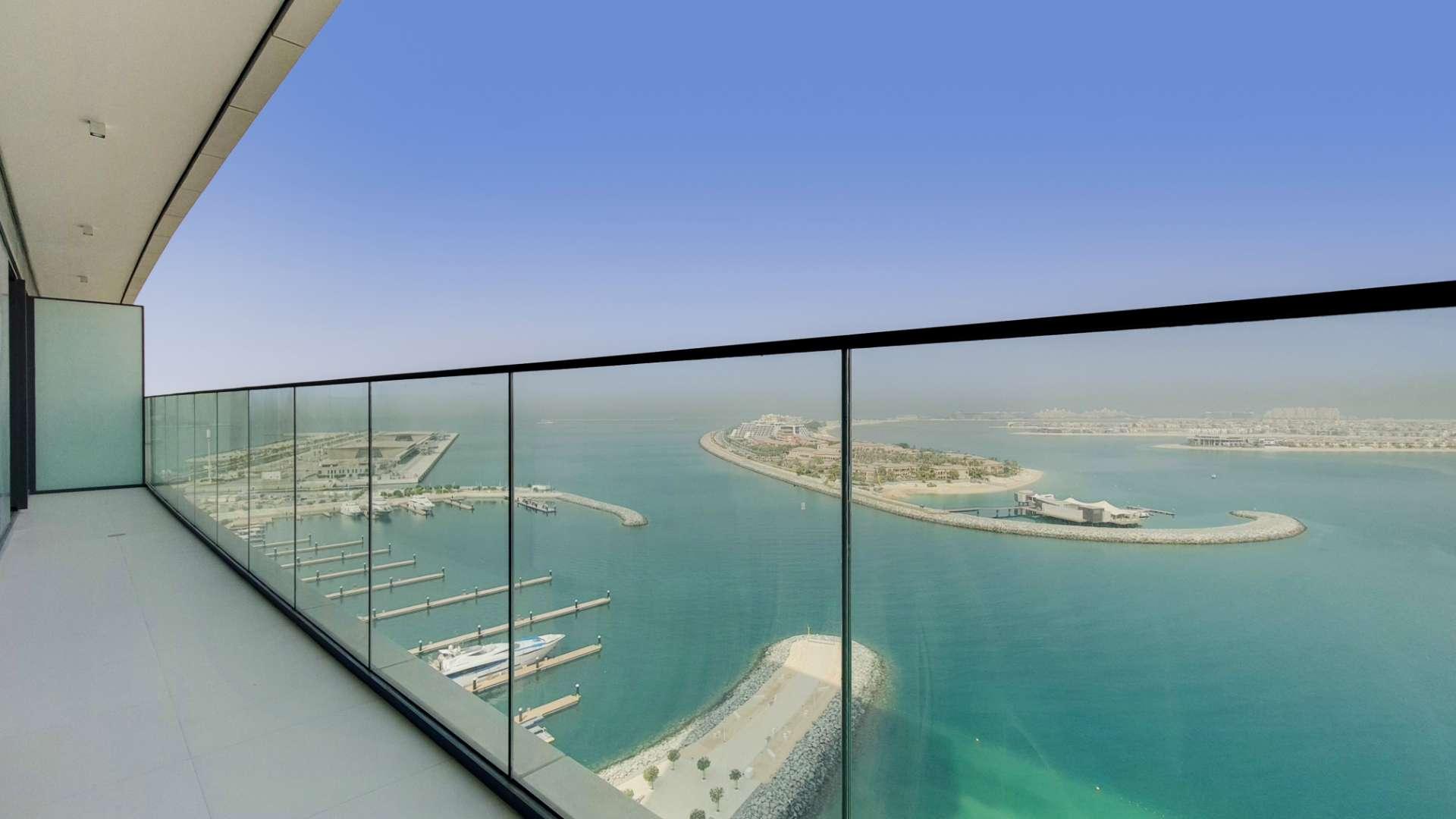 Contemporary apartment balcony with expansive sea views at Emaar Beachfront, Dubai Harbour