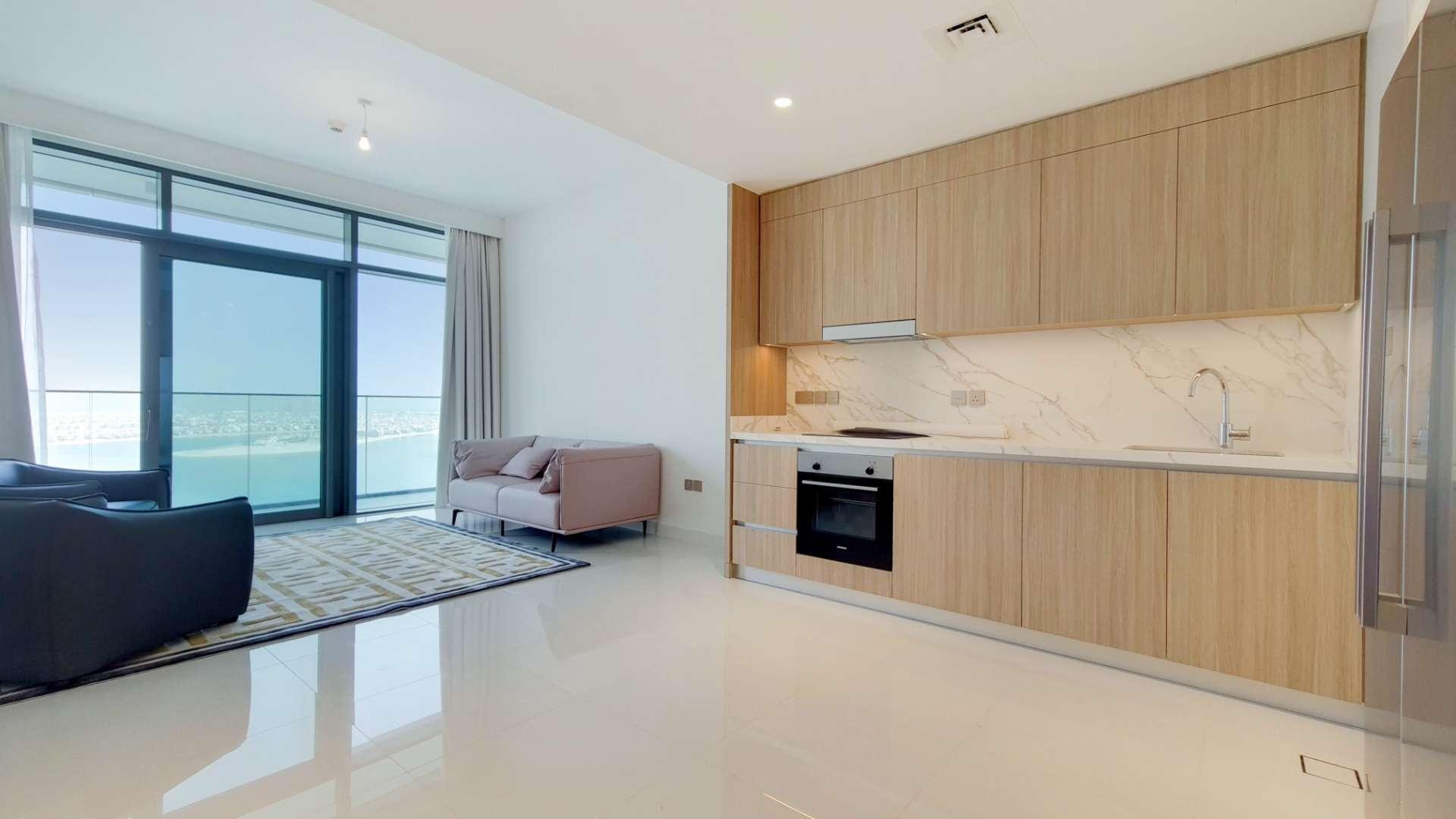 "Stunning sea views from Emaar Beachfront apartment in Dubai Harbour, available for rent.",Contemporary Emaar Beachfront apartment with sea views, modern kitchen, and spacious living area