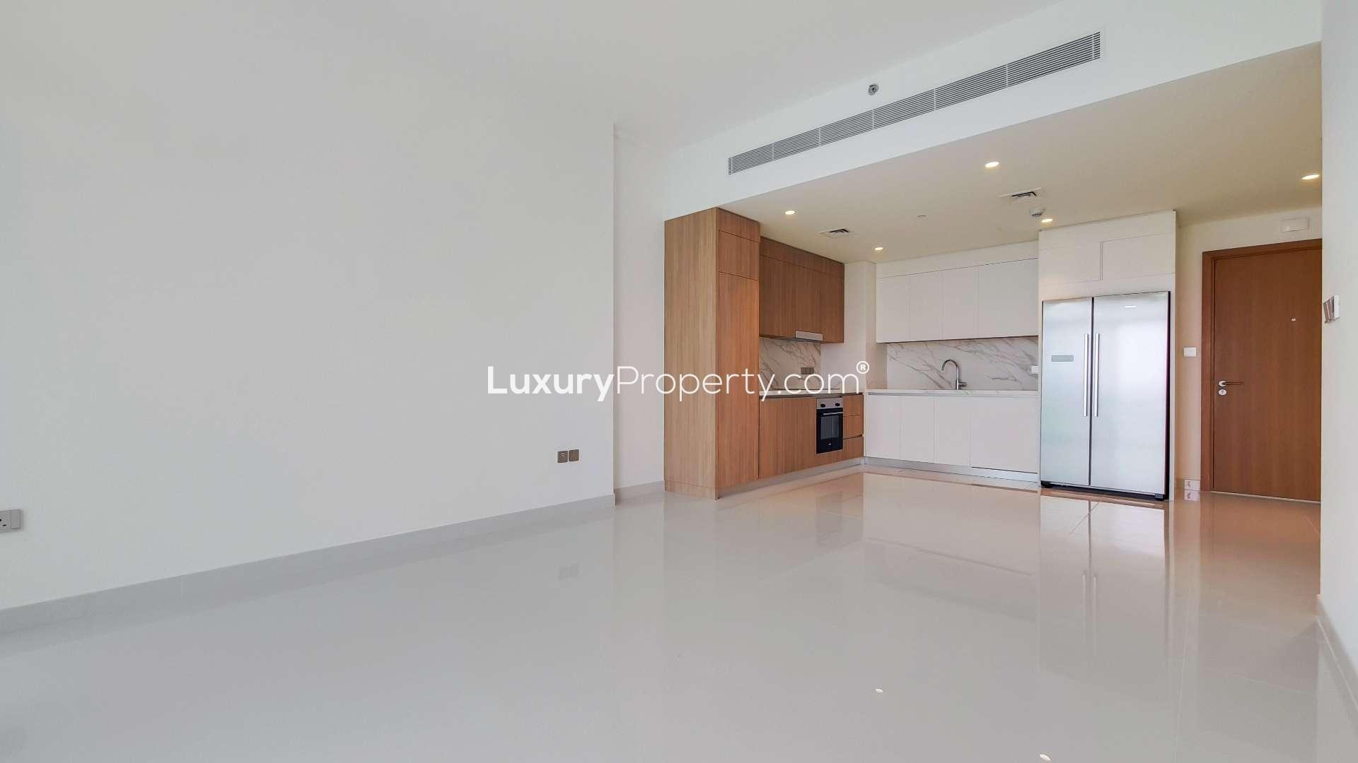 Modern kitchen interior in luxury Dubai Harbour apartment, Emaar Beachfront, with wooden cabinets